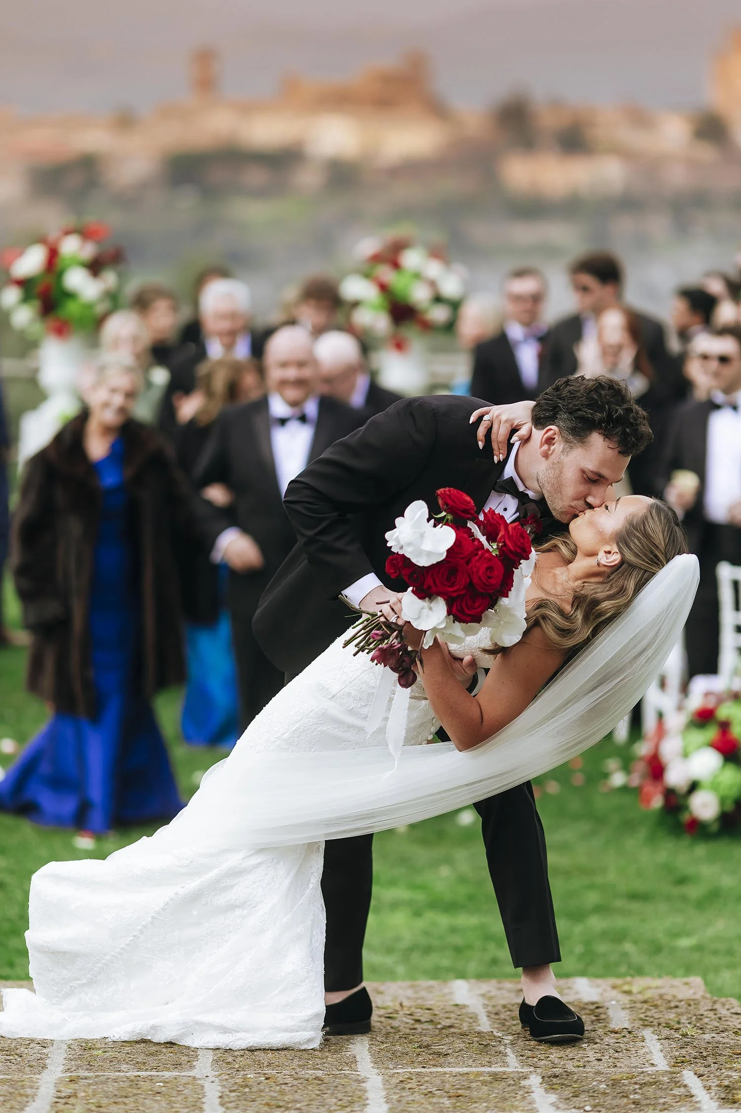 Bride and groom kissing after the ceremony at Pietra Campana wedding venue in Orvieto, Umbria. The town of Orvieto in the background. Photo by Rellini Art Studio, best wedding photographer in Umbria