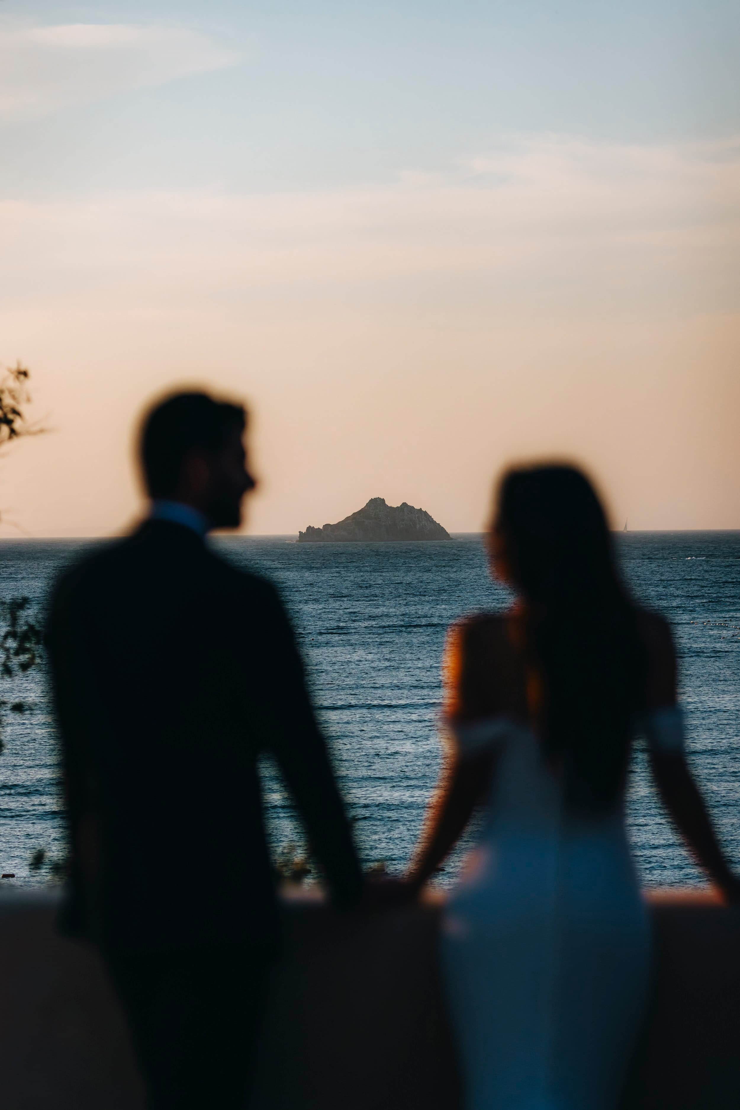 Romantic photo by Rellini art studio, bride and groom looking at each other in front of the sea in Bodrum Turkey