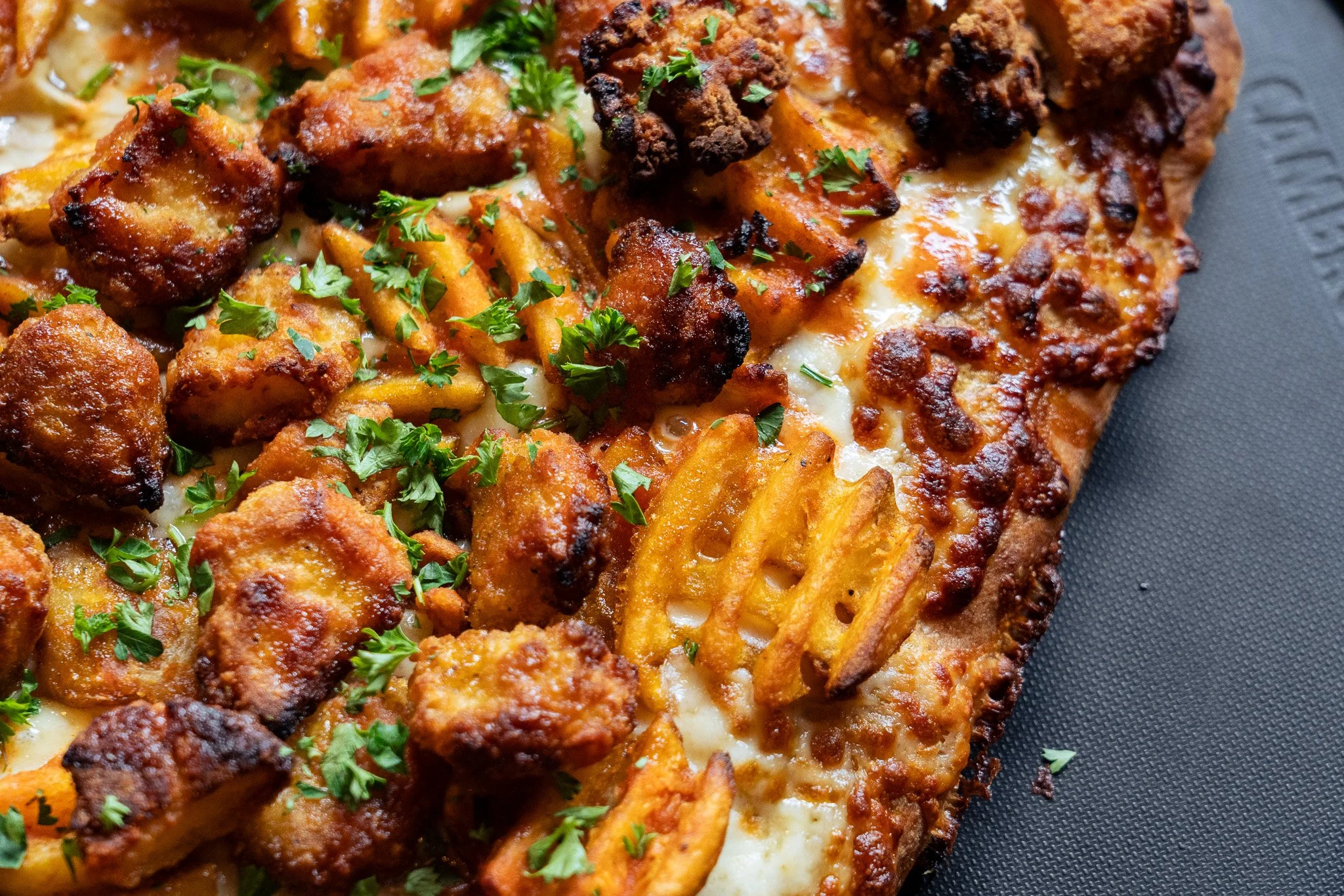 Chicken & Waffle Fries: Sweet mustard sauce, mozz, breaded chicken, impossible nuggets, or tofu, seasoned waffle fries, maple butter and hot sauce drizzle, parsley.