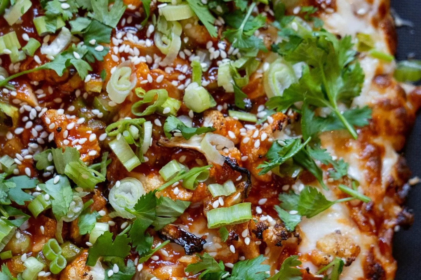 Gobi Manchurian: Manchurian sauce, mozz, crispy cauliflower, green peppers, scallions, sesame seeds, cilantro.