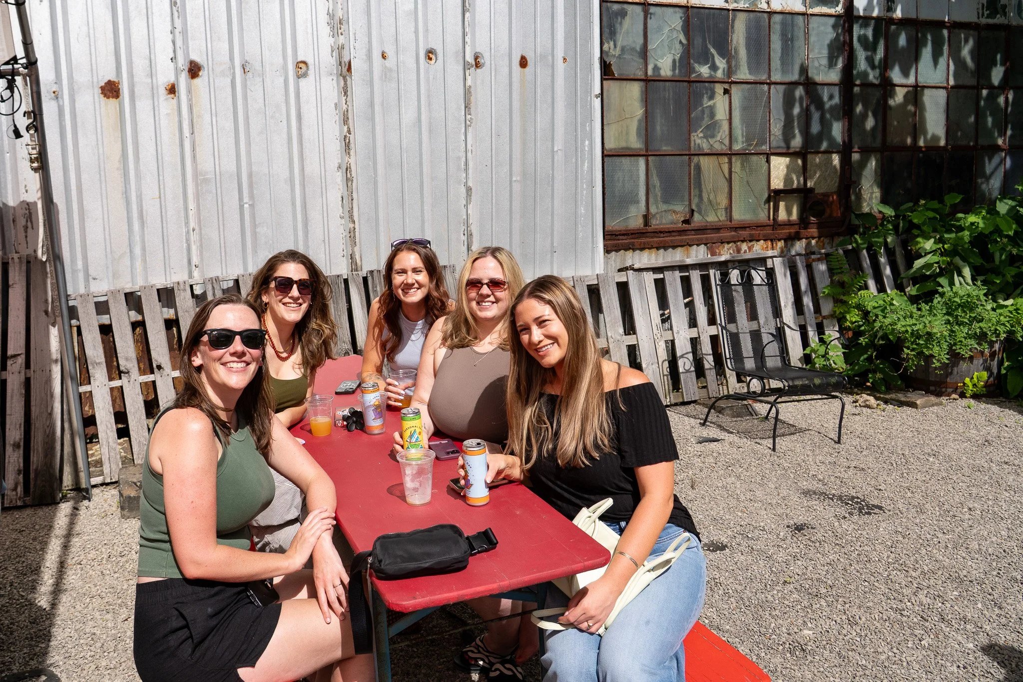 Group of five women smiling while enjoying the beer garden