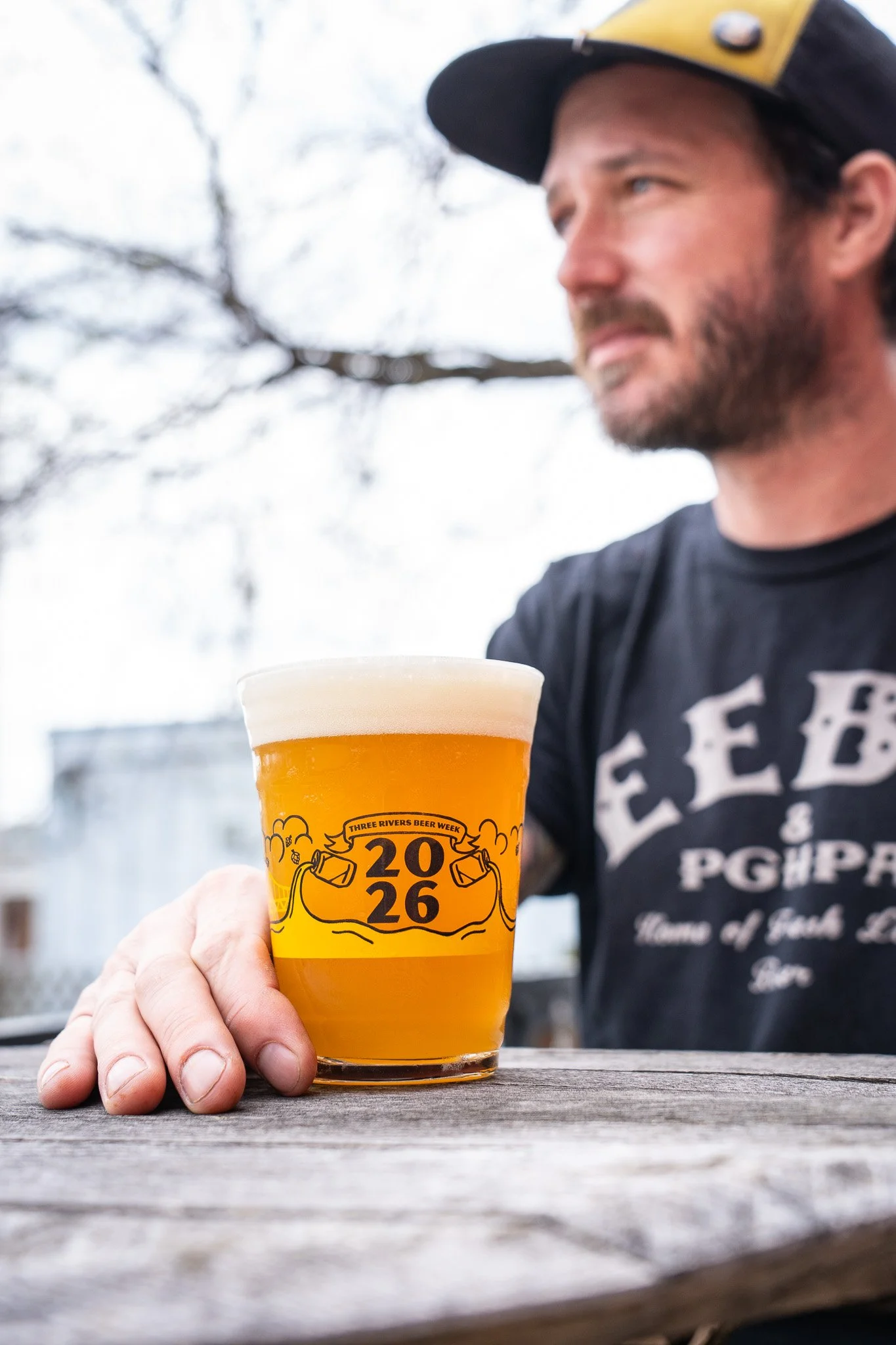 Male staff holding beer glass