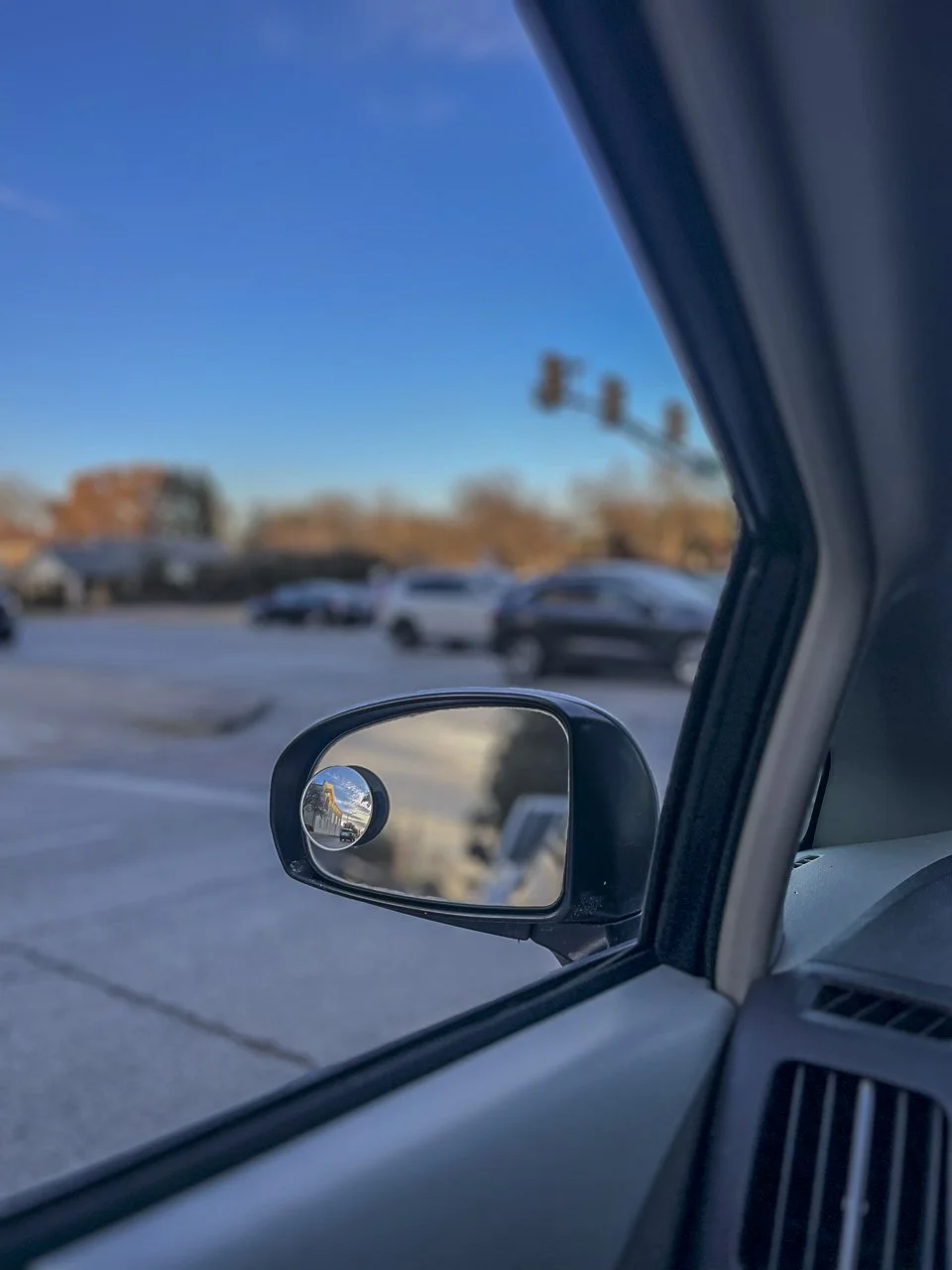 "This photo initially just looks like a rearview mirror of my 2010 Toyota Prius as I wait for the light at the intersection of University and Cantey to turn green. But below the surface, it reminds me to stop focusing so much on what has happened in 
