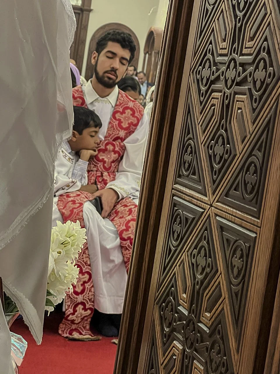 "As a Coptic Christian, I spend the nights before Easter or Christmas in prayer with my community, up until 12:00 am, then we break our Lent fasting with a huge feast. My brother and I are both deacons, but we are also big sleepers. This photo was ta