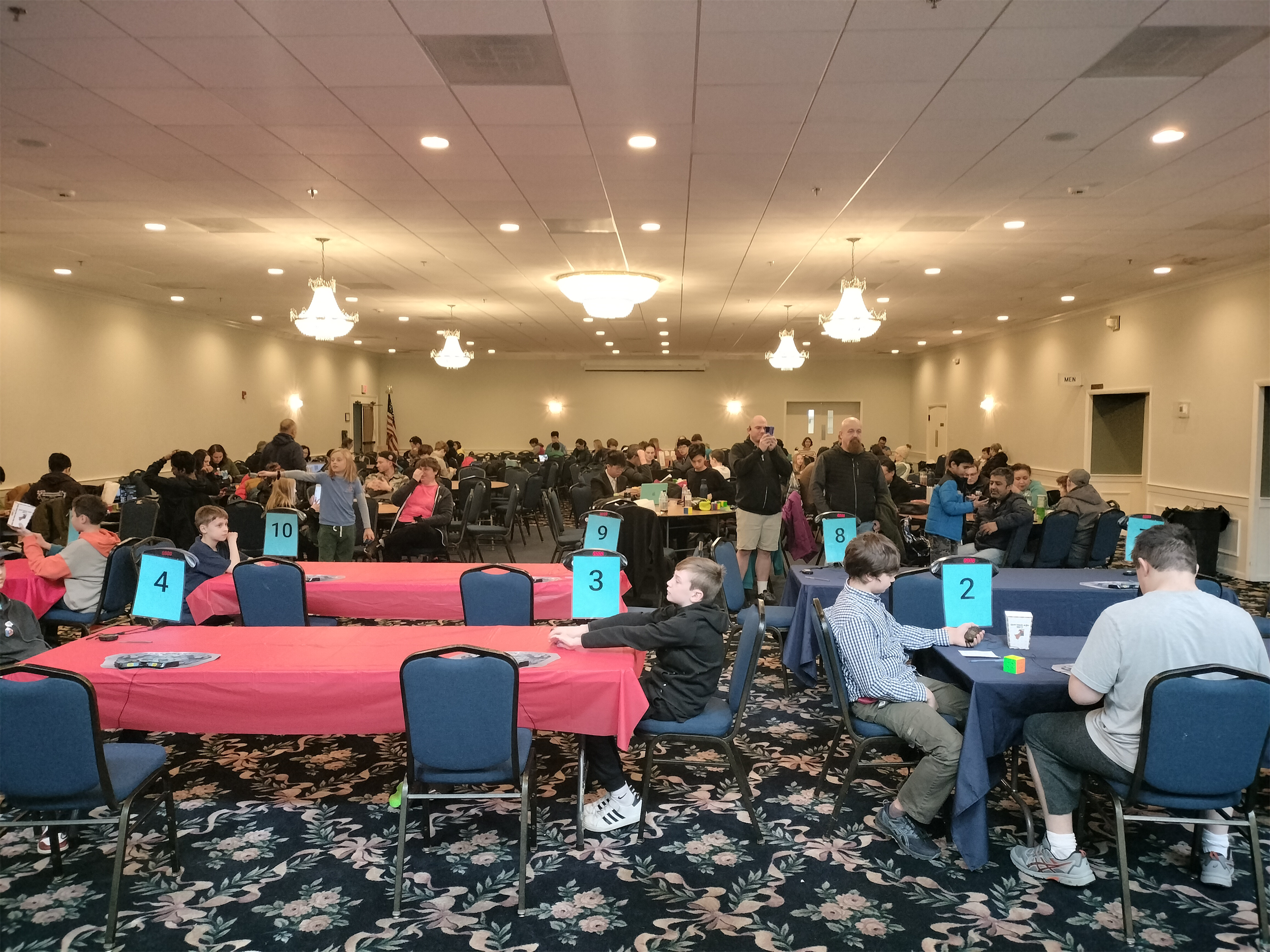 "Community is in lots of strange places! In late January, 80 New Englanders who enjoy speed-solving Rubik’s Cubes came together at The Battle of Lexington 2024 to share each other’s company and compete for the best times."

- Nico