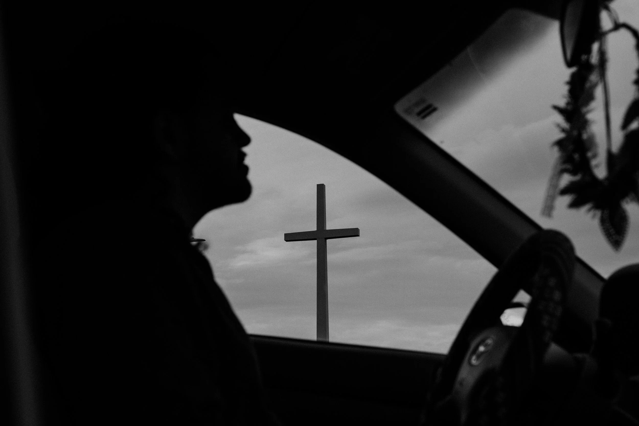 This is my husband, Alejandro, in the car as he's driving, so you can kind of see the cross there in the distance.     — Joanna Schaus