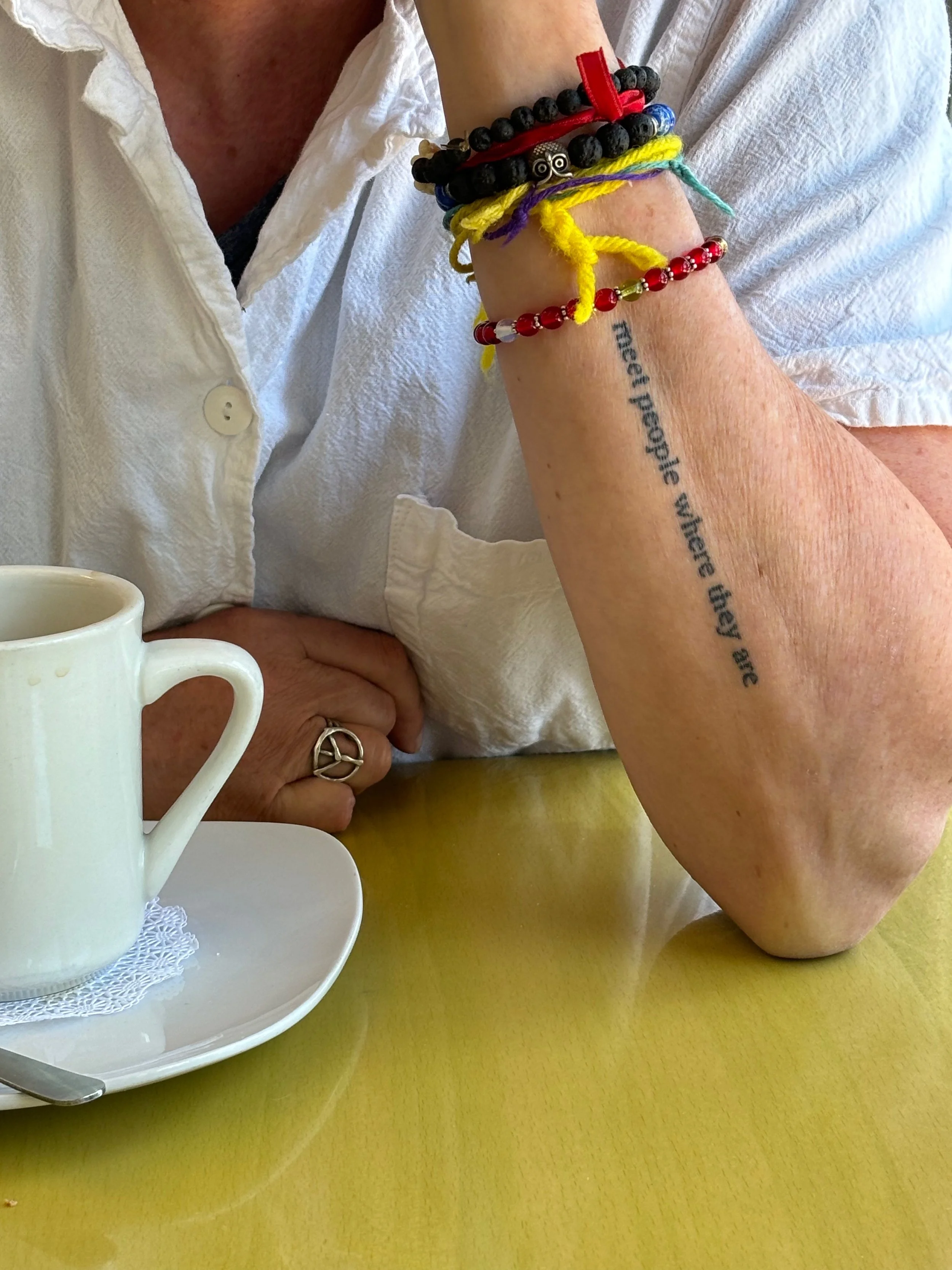 This one is my friend's arm, which I love that message, but she's wearing a red string, like a cabal string, and it's like it's a protection string and her peace ring and whatever.    

Red string: Jewish folk custom meant to protect people from harm