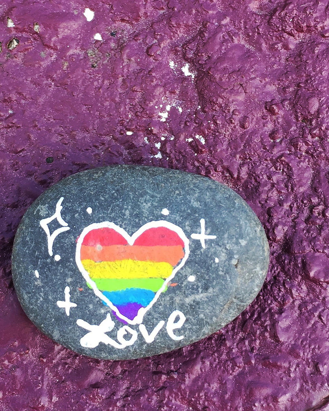 "A painted stone left on the mailbox post for anyone to find. At the time, my then partner and I were not 'out' to our coworkers, and since E lived on-farm, we'd have to wait until we were around the corner to hold hands.right about where the mailbox