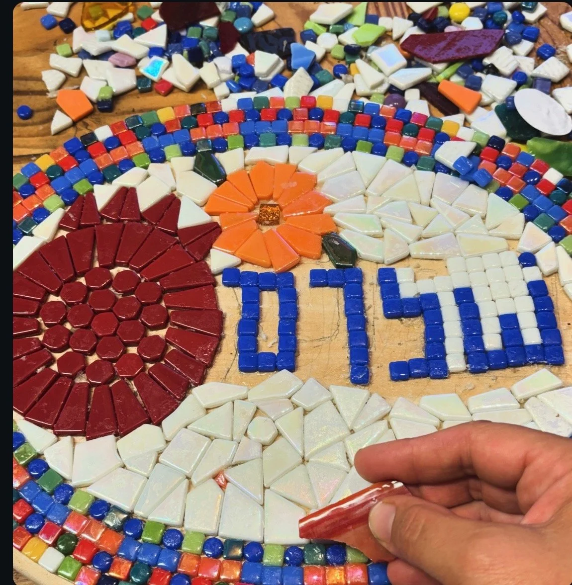 I was doing a mosaic class and I love the idea of bits and pieces coming together and this says shalom, which means peace. And it's like all these broken things coming together to form something beautiful and that's just a good message.    

[The] pi