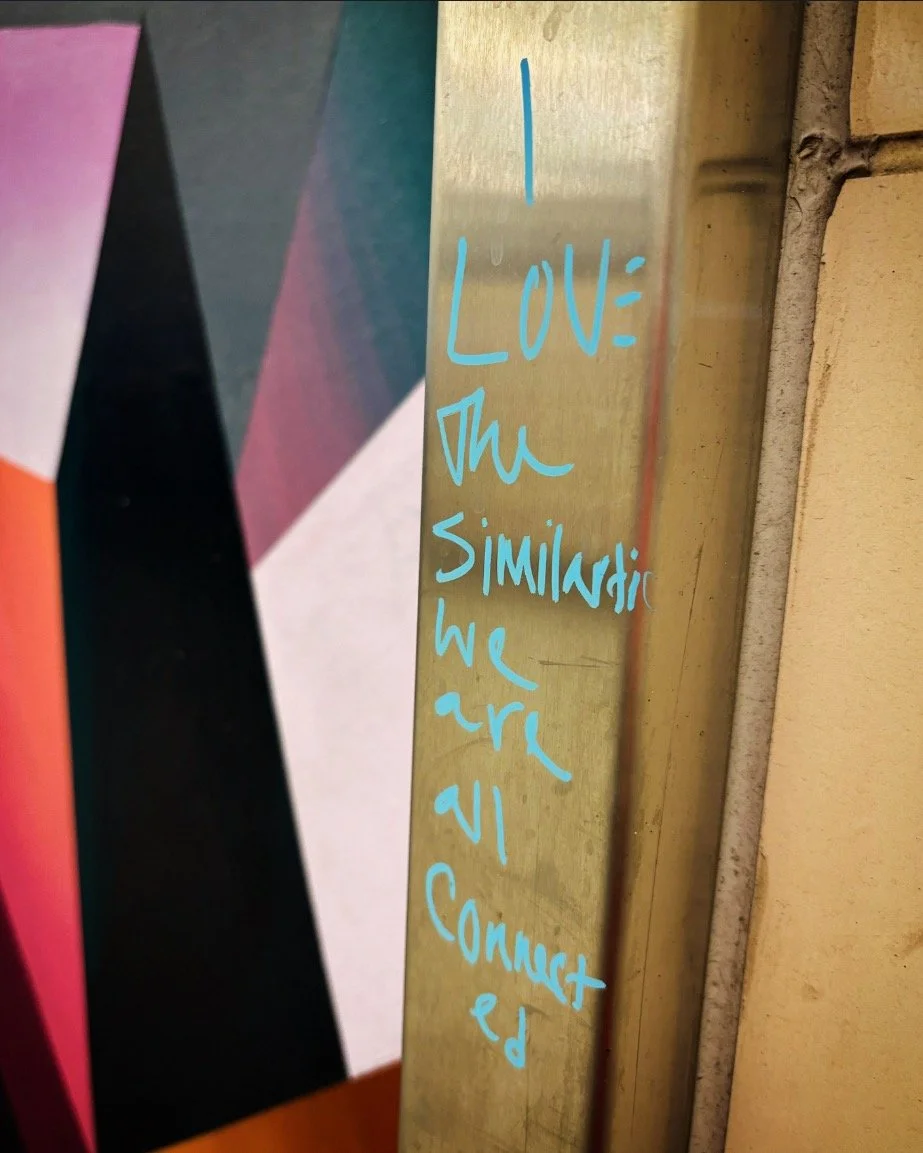 This is just some graffiti scrawled like a prayer wall in a city train station that I like and I think it kind of summarizes this whole program and it just says, I love the similarities. We are all connected. But actually I took this picture, I work 
