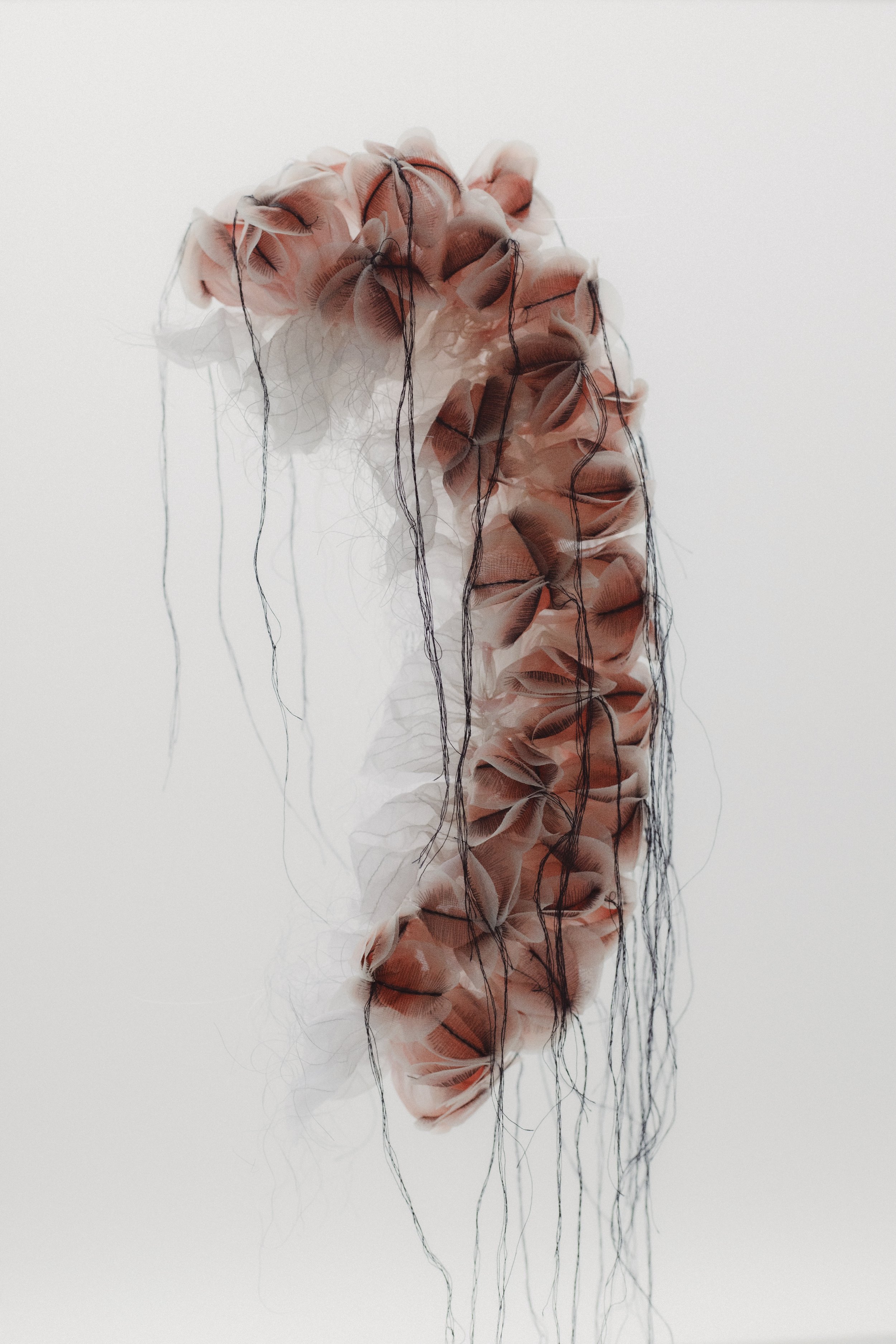 Heat-manipulated organza, textile print and threads.