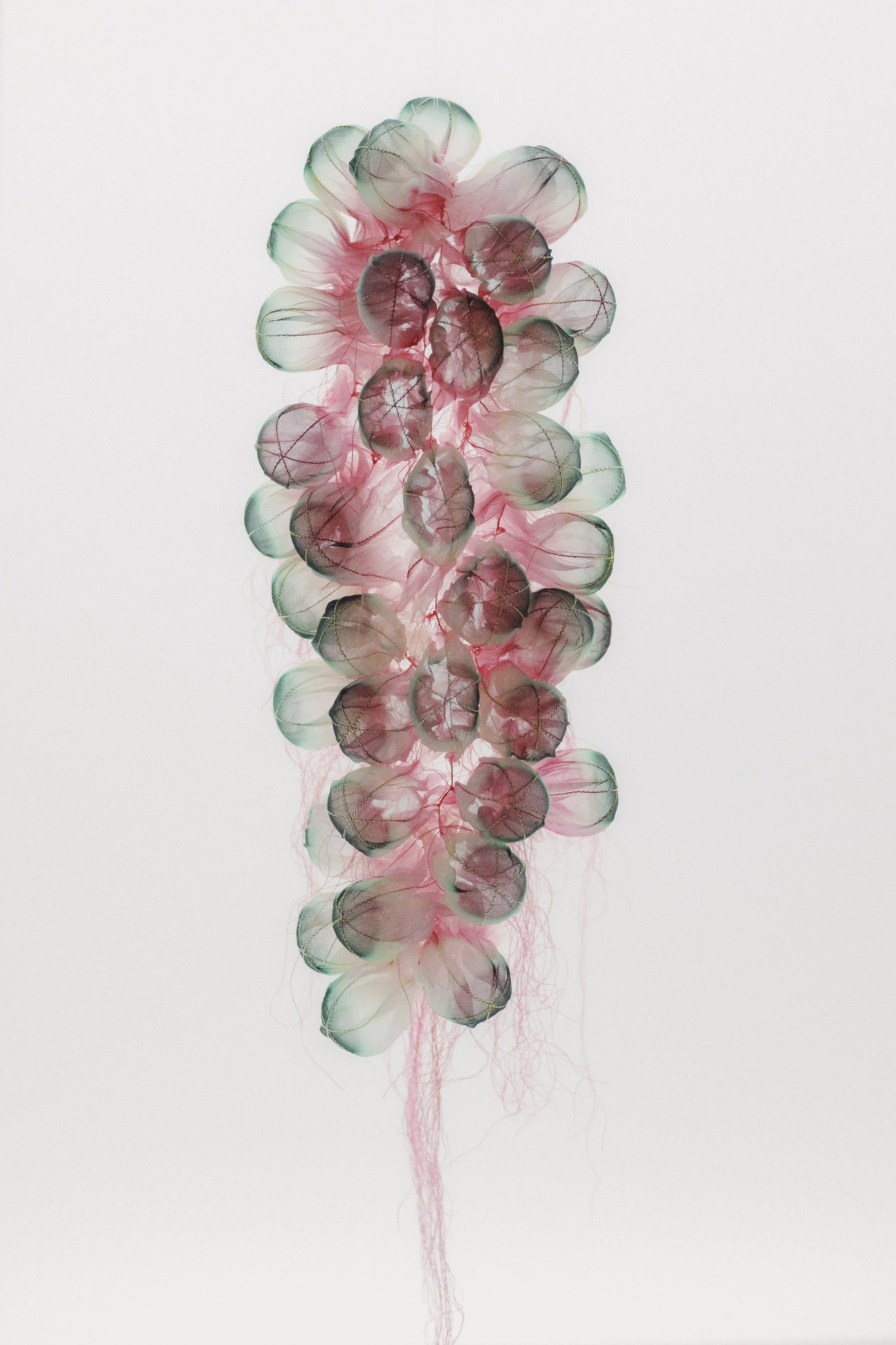 Heat-manipulated organza, dyed textile and threads.