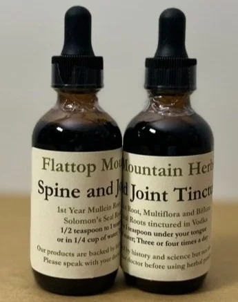 Two small amber glass bottles with black dropper caps, labeled as herbal tinctures for spine and joint health.
