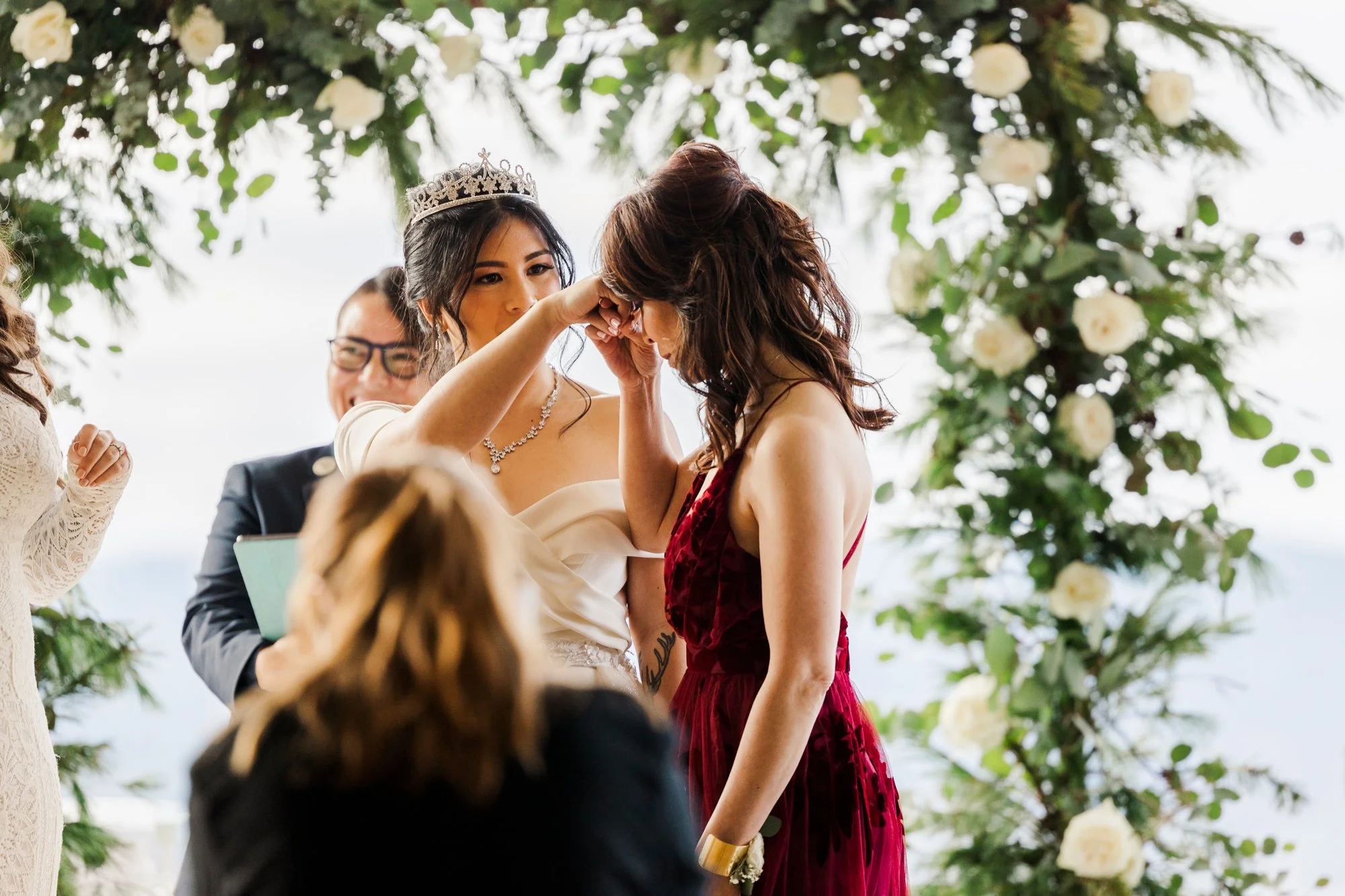 During this Hudson Valley multicultural ceremony officiated by queer officiant from Once Upon A Vow, LGBTQ couple include their mothers with hand to forehead