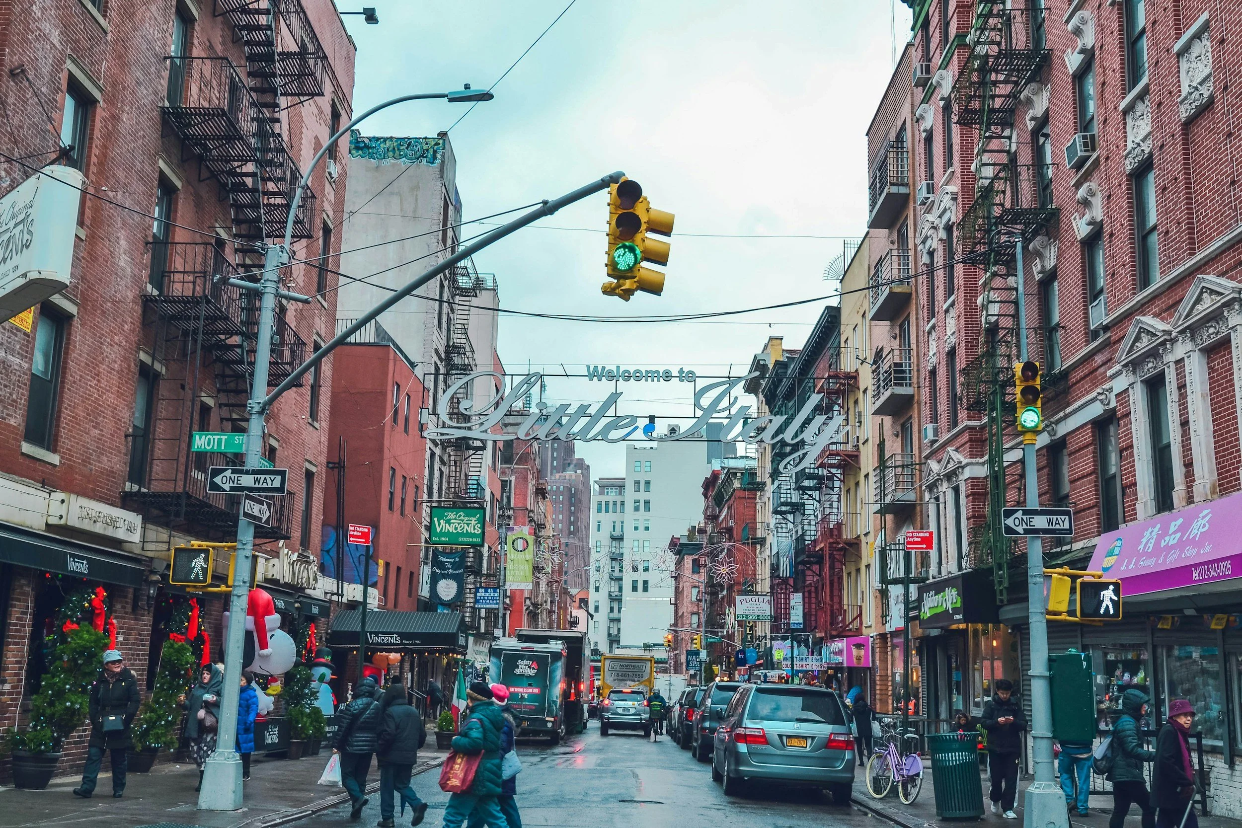 Image of a street in NYC's Little Italy with pedestrians walking in the street, neighborhood near NYC City Clerk's Office, the Marriage Bureau