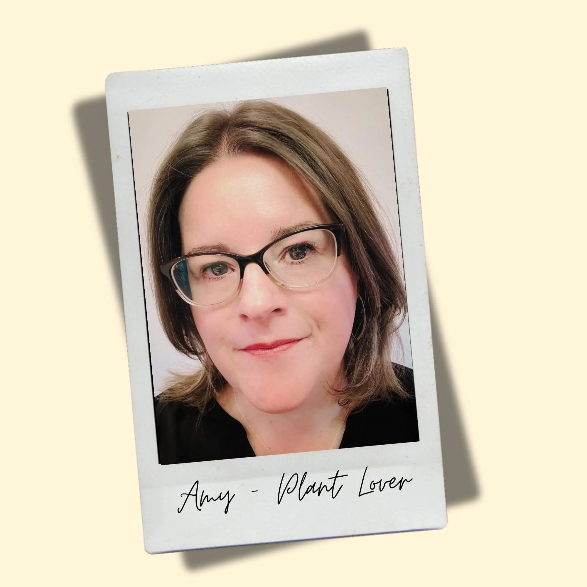 woman with brown hair glasses black shirt in polaroid frame