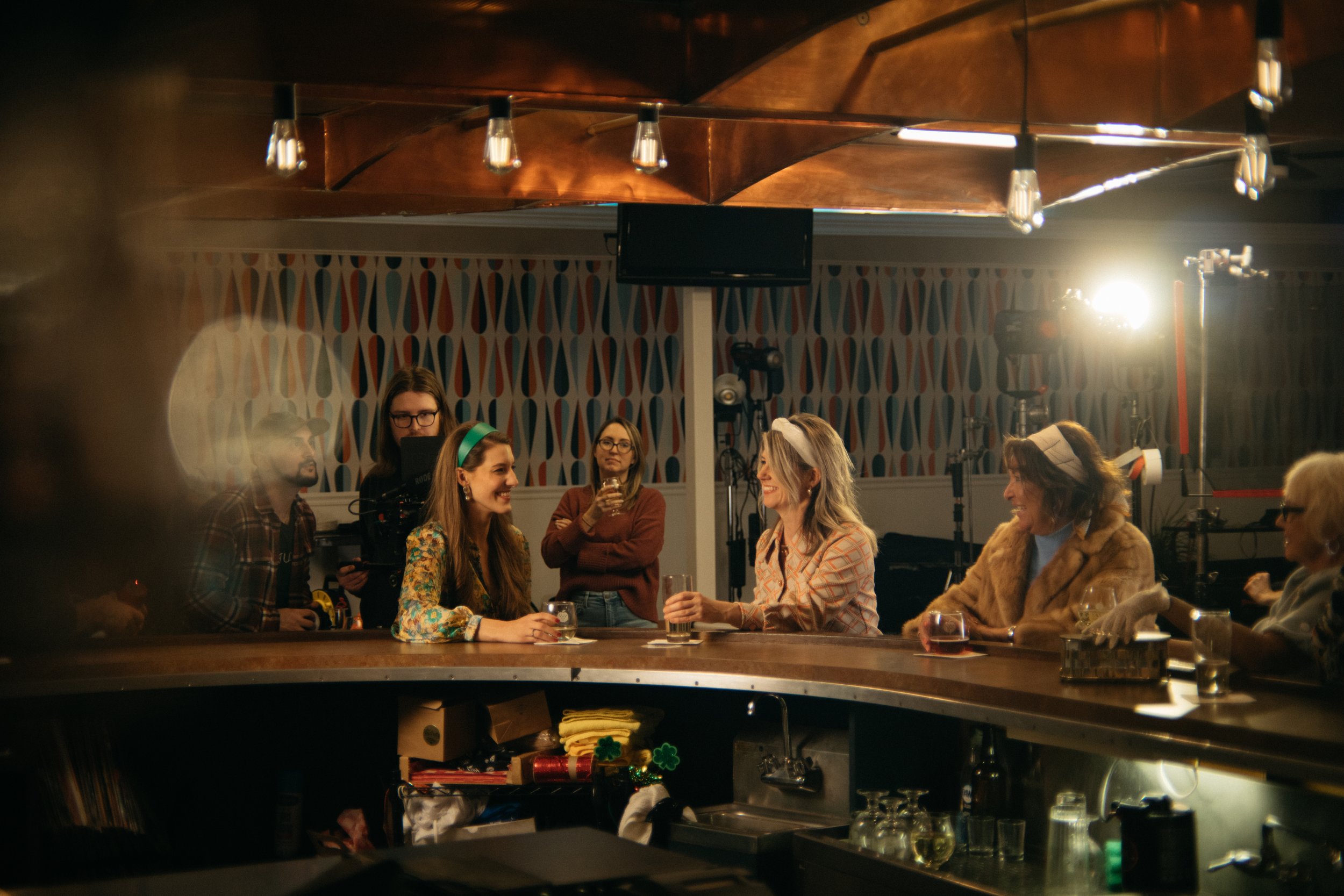 women sit at a bar with drinks.jpg