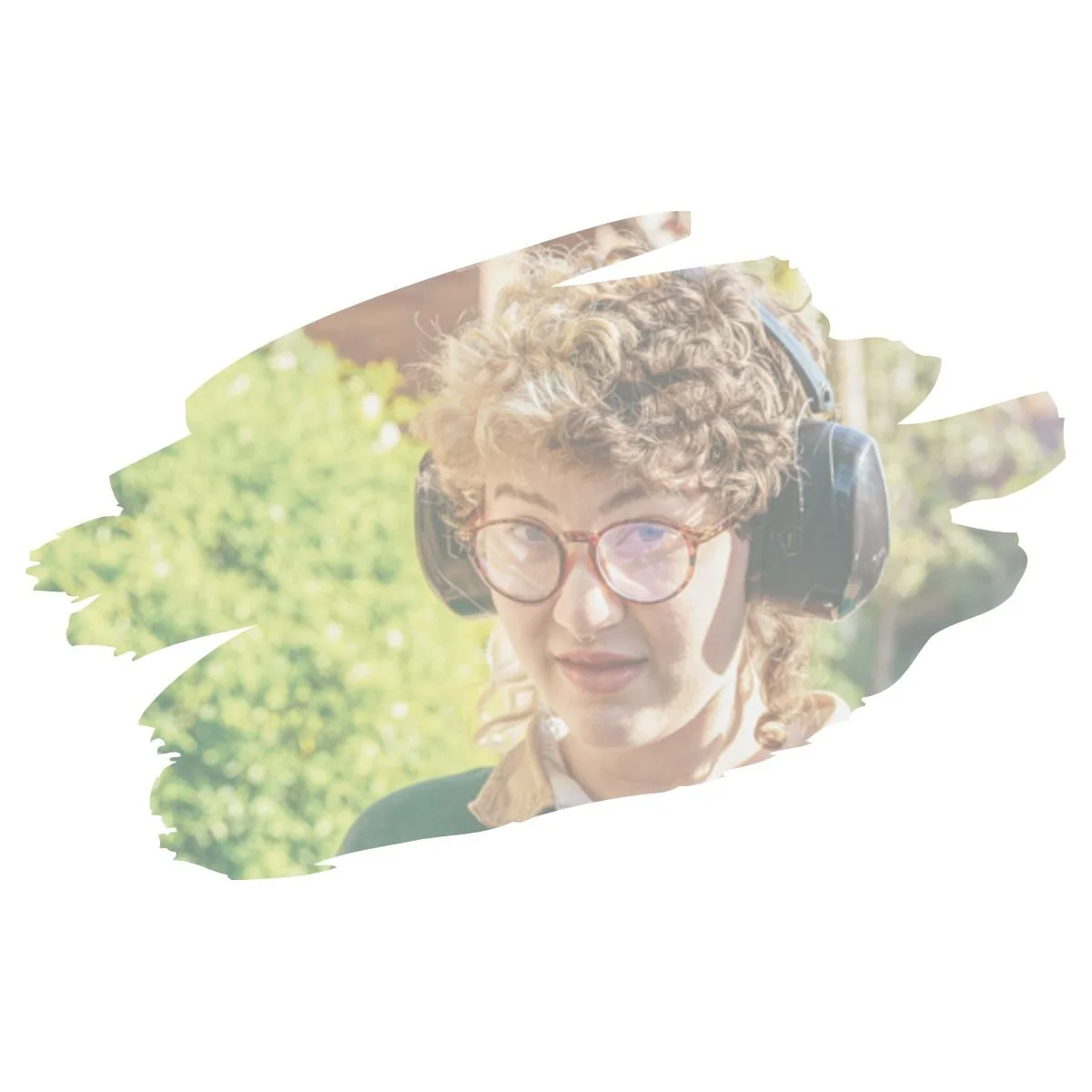 [Image] Non-binary person with glasses and large black headphones, neurodivergent therapy for teens and young adults in Denver, CO at Interfaith Bridge Counseling