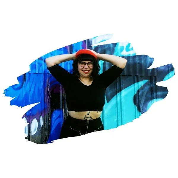 [Image] Scribble picture of Caucasian woman with hands on her head in front of a graffiti painted wall.