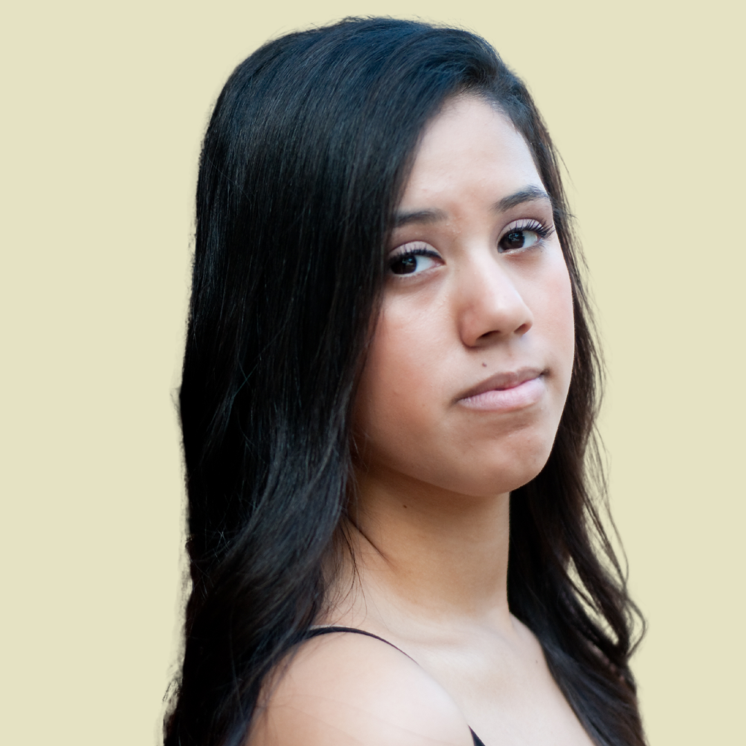 [Image] Indigenous young adult with long black hair, looking forward and seeming disappointed. Denver Young Adult Stress Management.