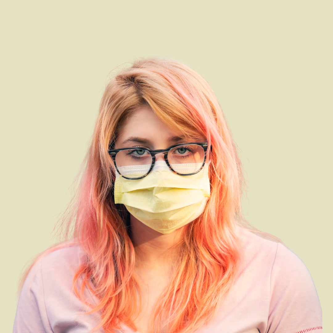 [Image] COVID conscious teen girl with glasses and long faded pink hair looking forward. Denver Young Adult Therapy for Stress.