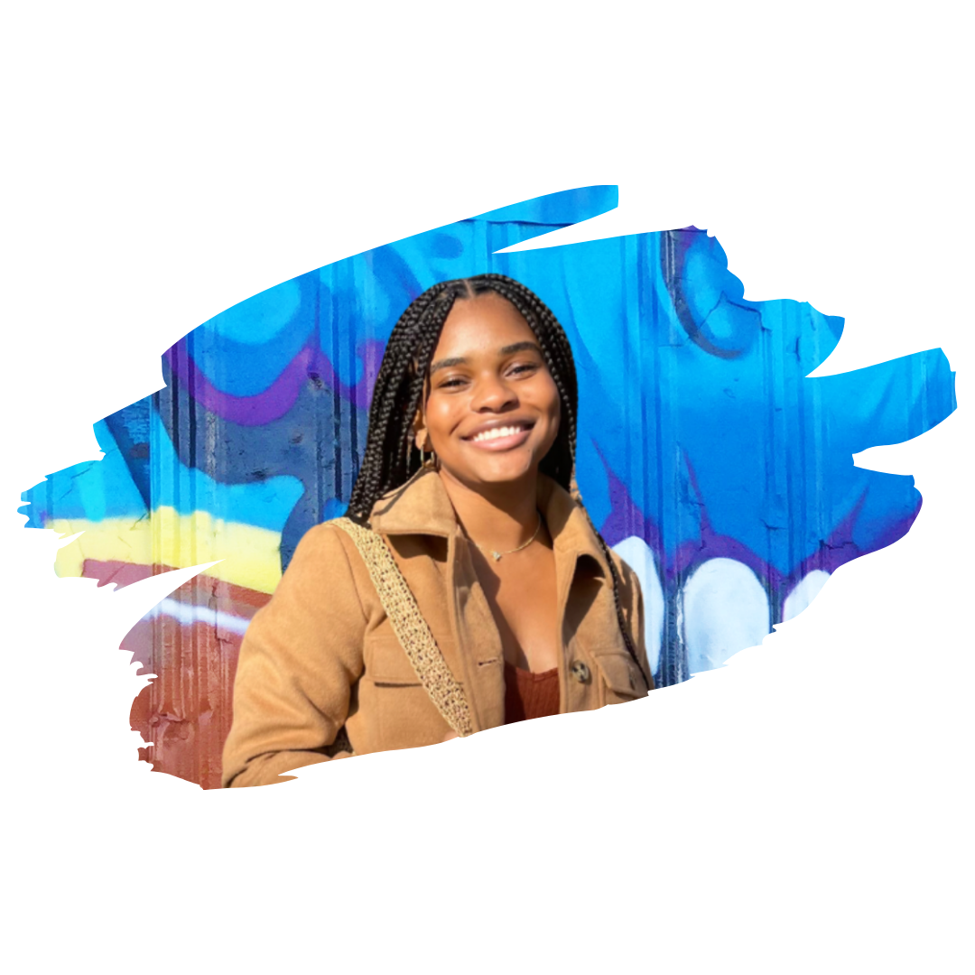 [Image] Black woman smiling in front of a graffiti art mural; Lorie Karim, Teen Therapist and Young Adult Therapist at Interfaith Bridge Counseling in Denver, CO.