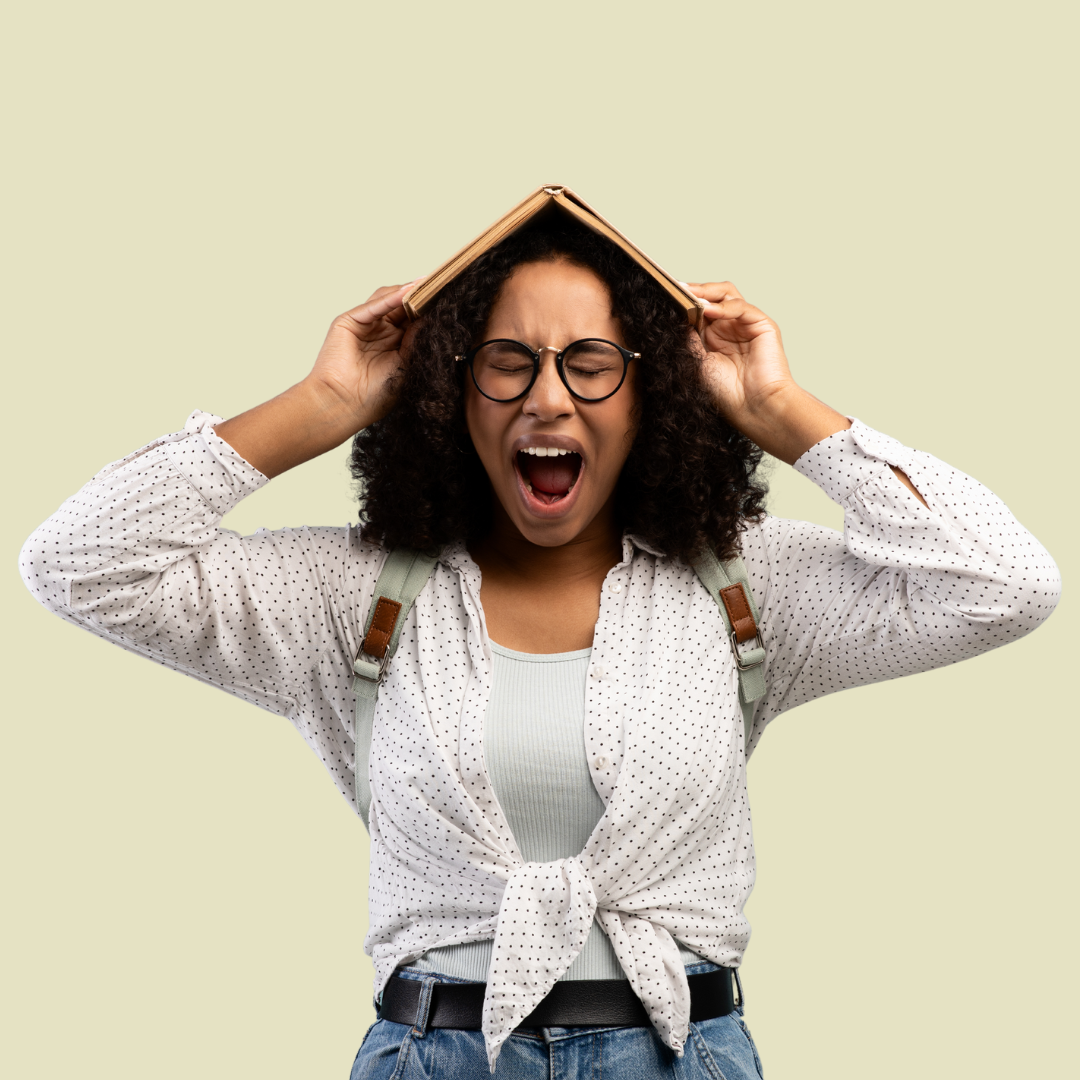 [Image] Black tween with bag pack holding a book overhead and screaming. Denver Teen Stress Management..