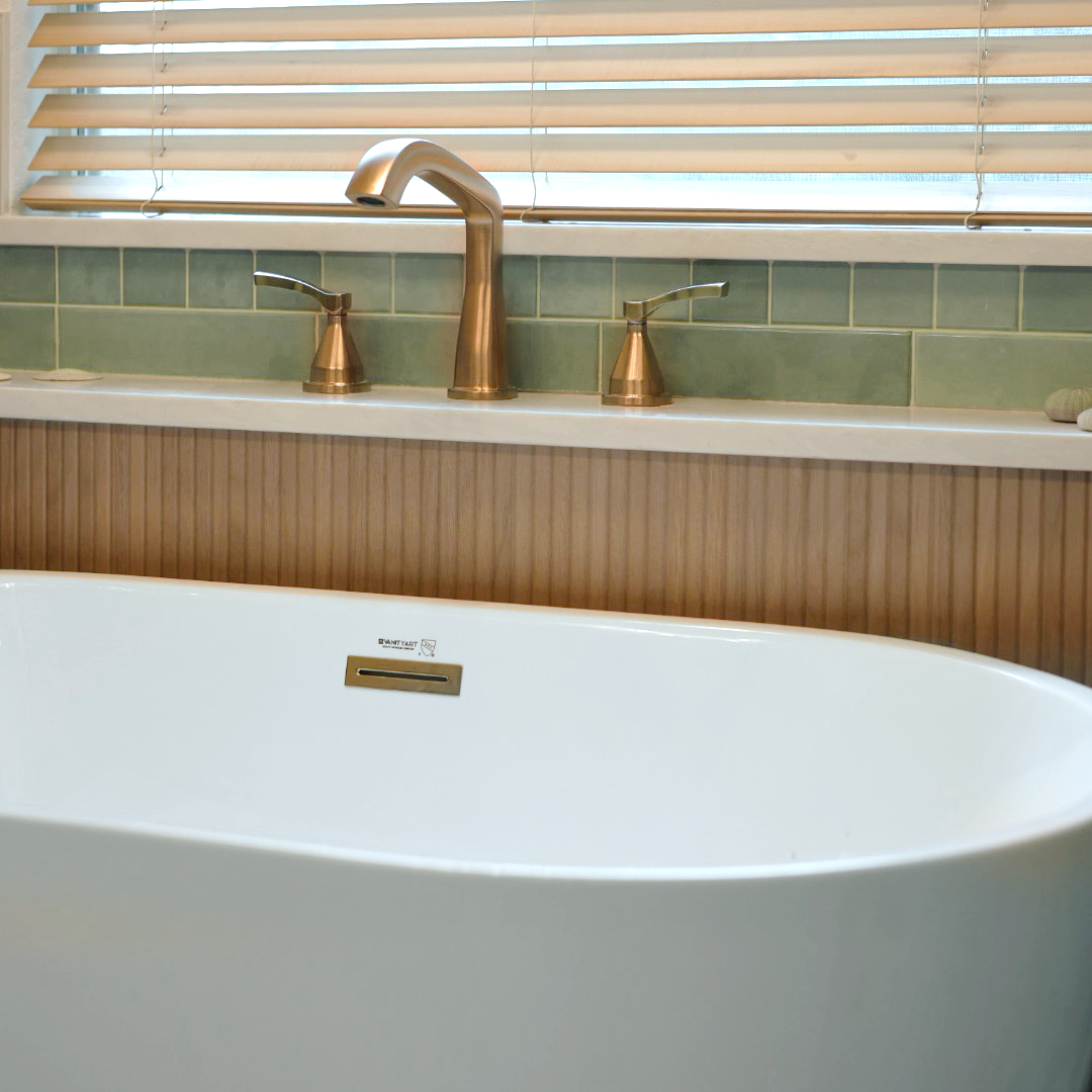 Freestanding tub with built-in ledge and deck mount faucet — flexible plumbing design solution