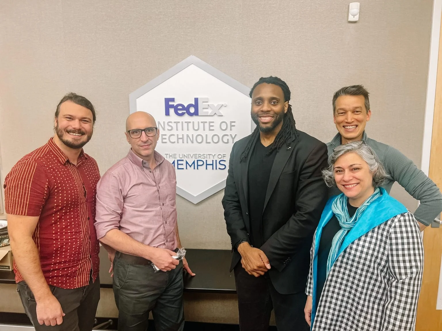 Dr. Charleson Bell posing with some of the Memphis team