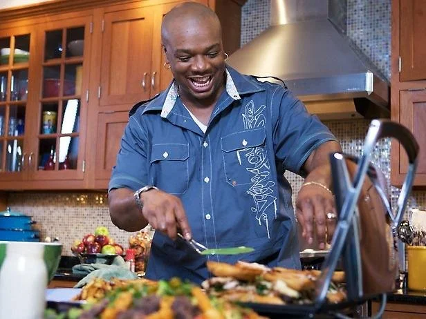 Man cooking in a kitchen with a sandwich grill