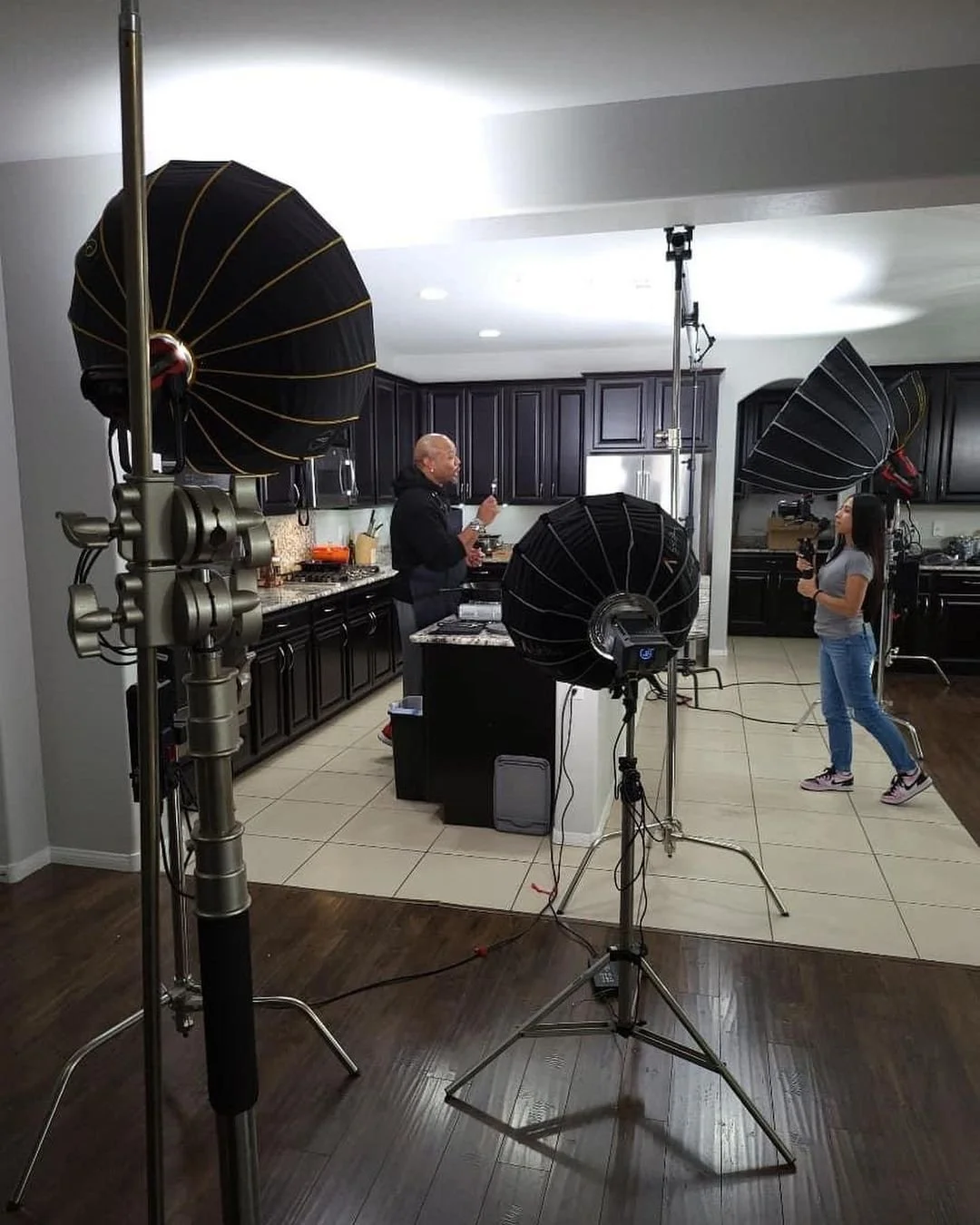 Indoor kitchen filming setup with studio lights