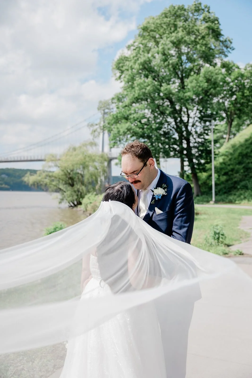 Bride veil flowing in wind along Hudson River