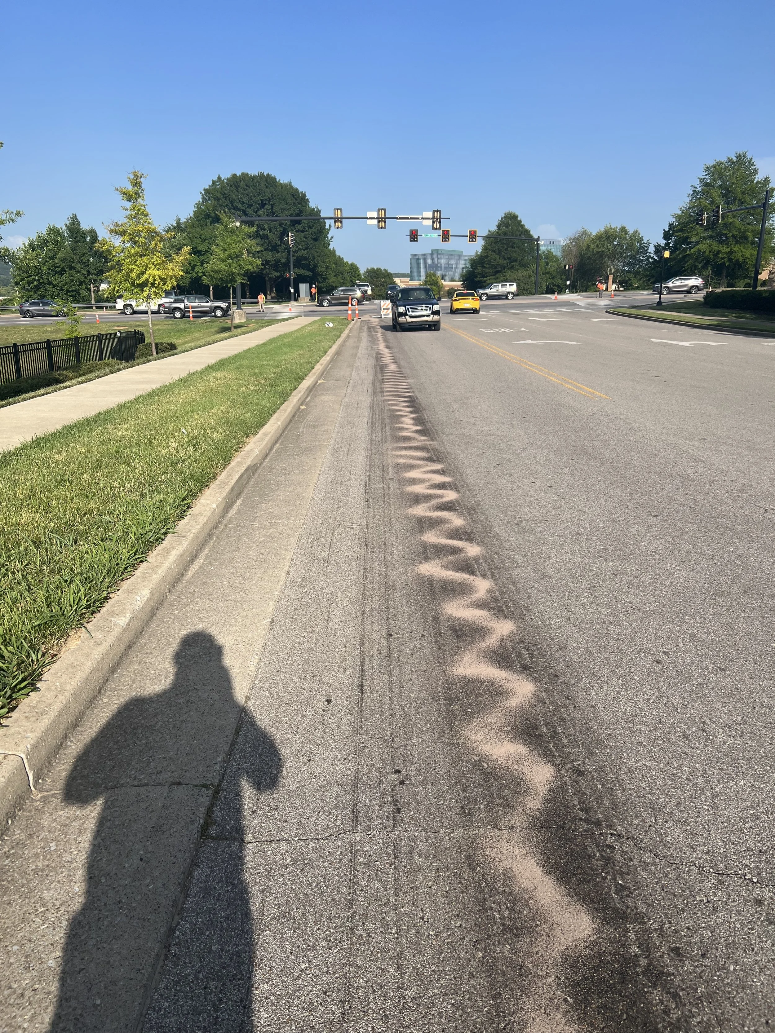 Roadway fuel spill pattern documented by Enviro Medics during emergency environmental cleanup at city intersection in Franklin, Tennessee.