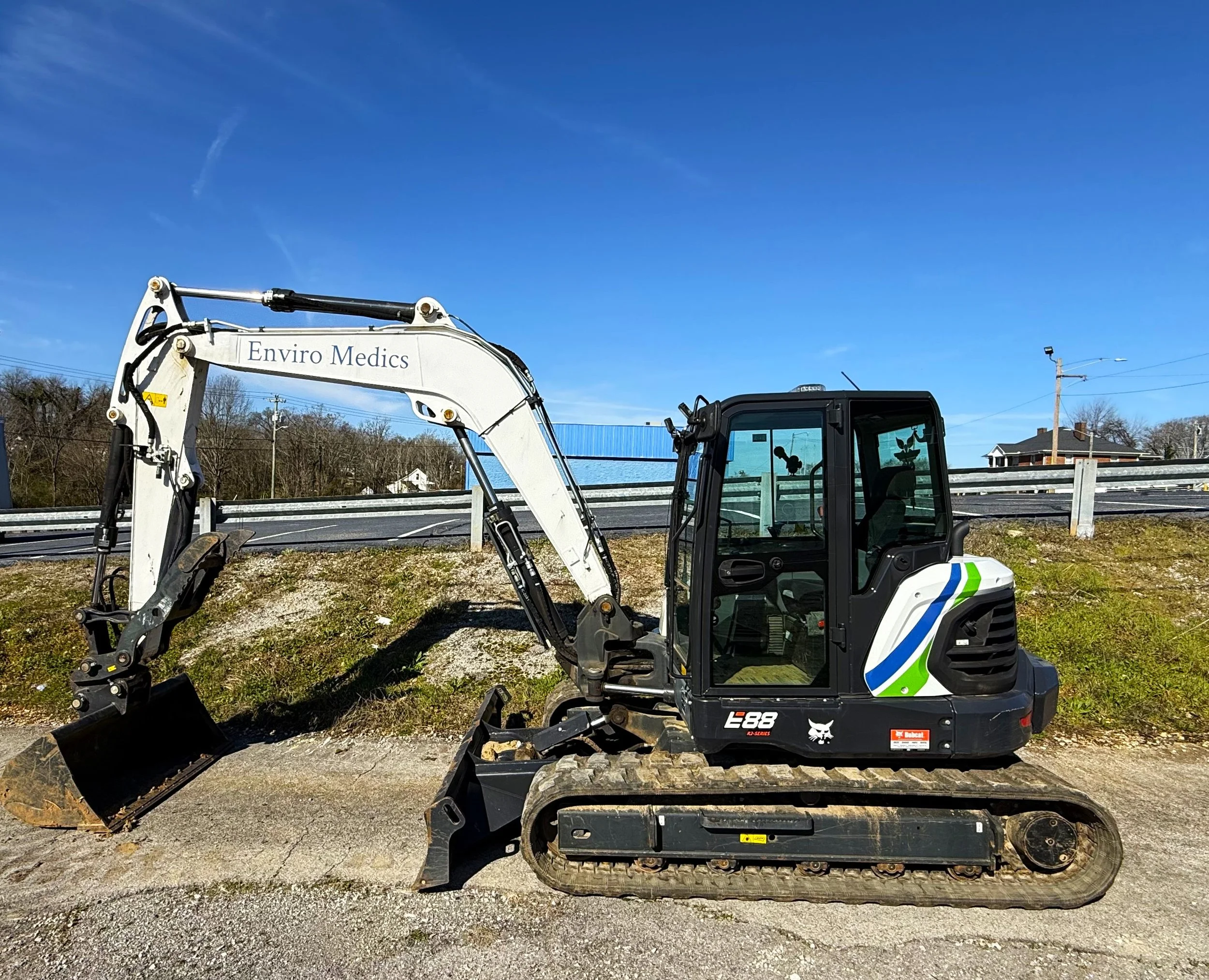 Enviro Medics excavator ready to work with special equipment to work on roadways.