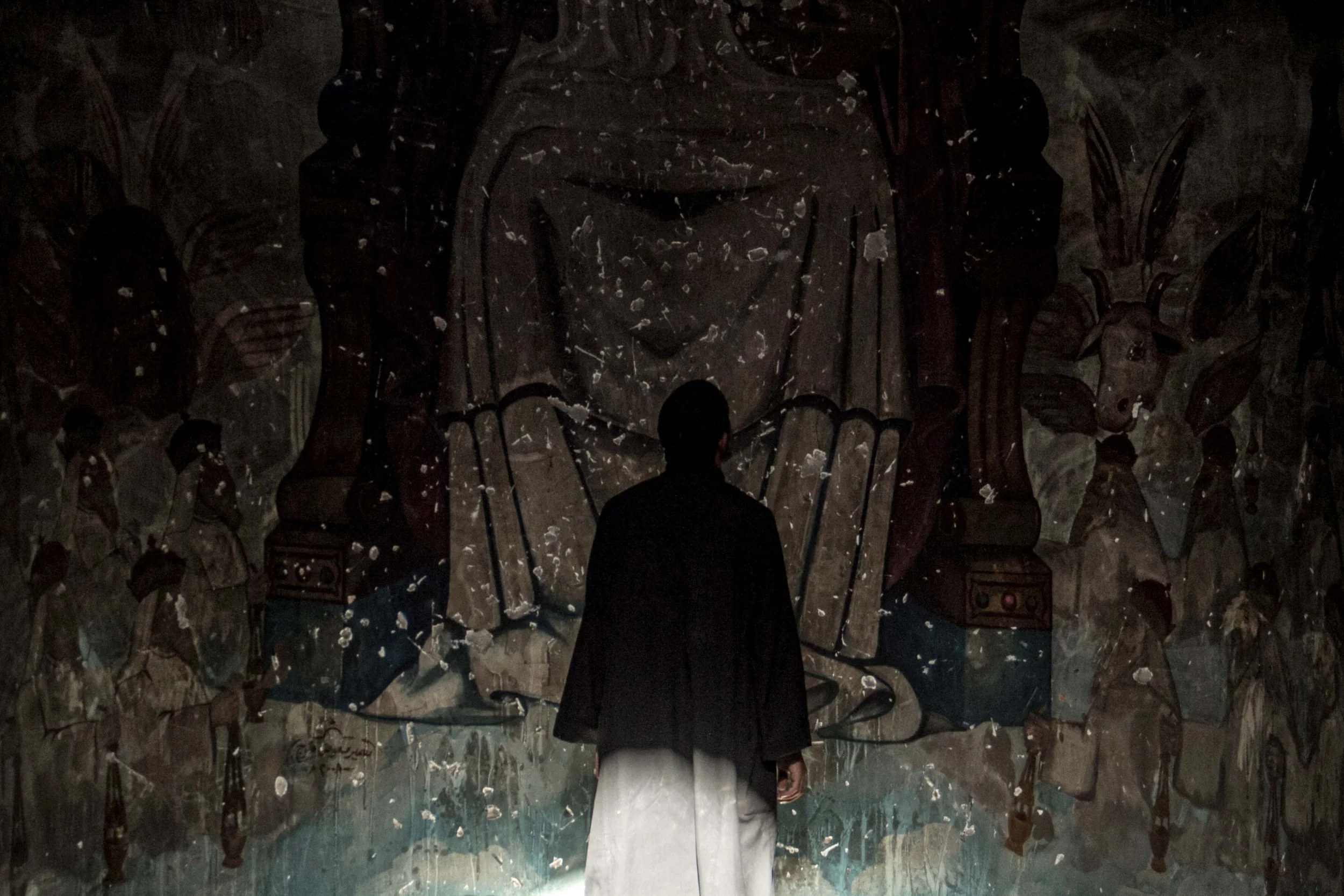 Sohag, Aug 2013, A coptic priest in front fo the destroyed alter of his church after it was ransacked, looted and burned by an angry mob of Muslim Brotherhood supporters.