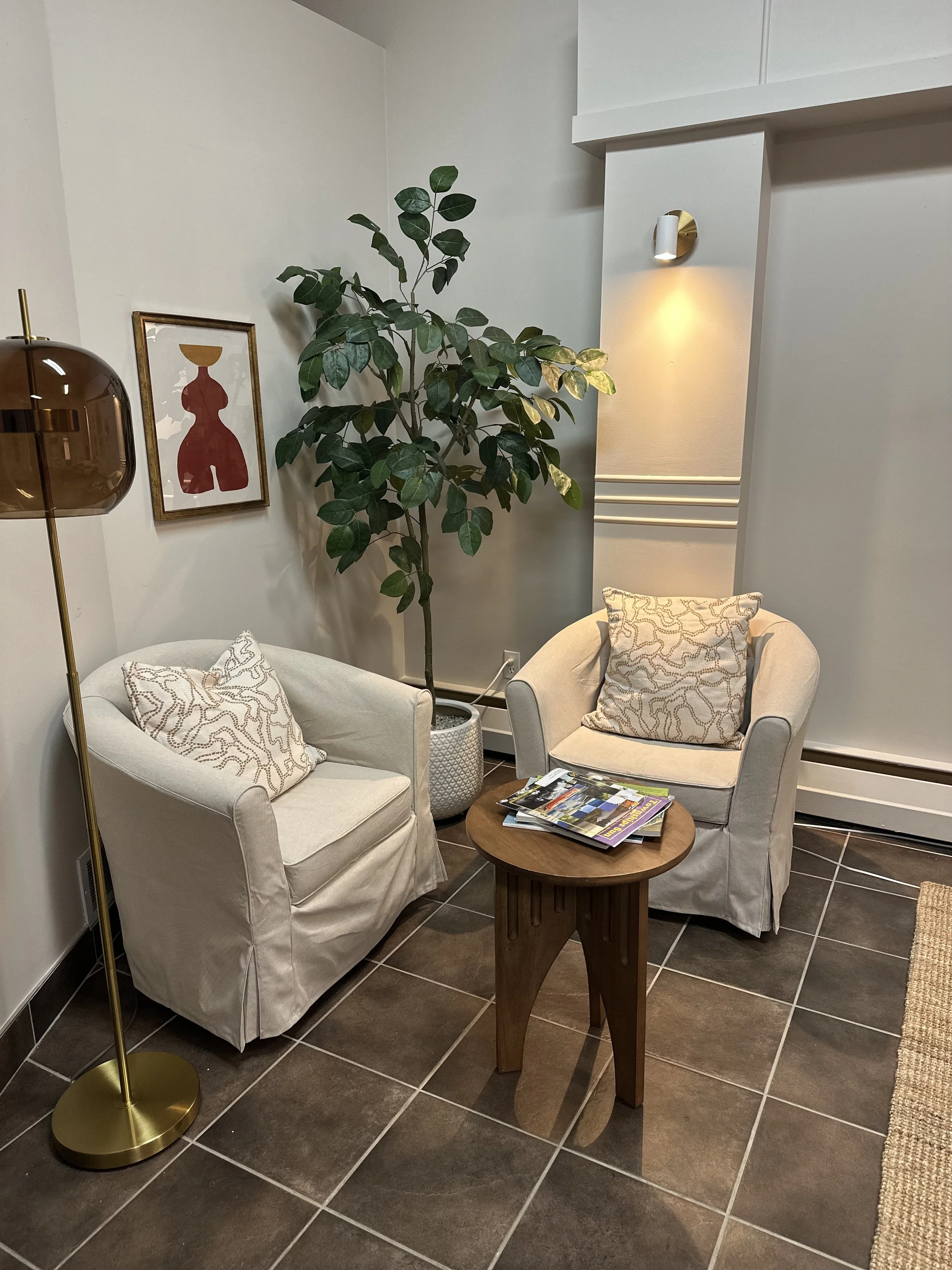 AFTER - Reception.  Existing armchairs get a facelift with new slipcovers and pillows.