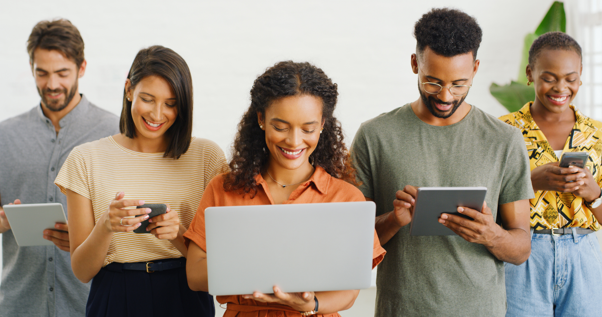 A group of people standing together, looking at their devices
