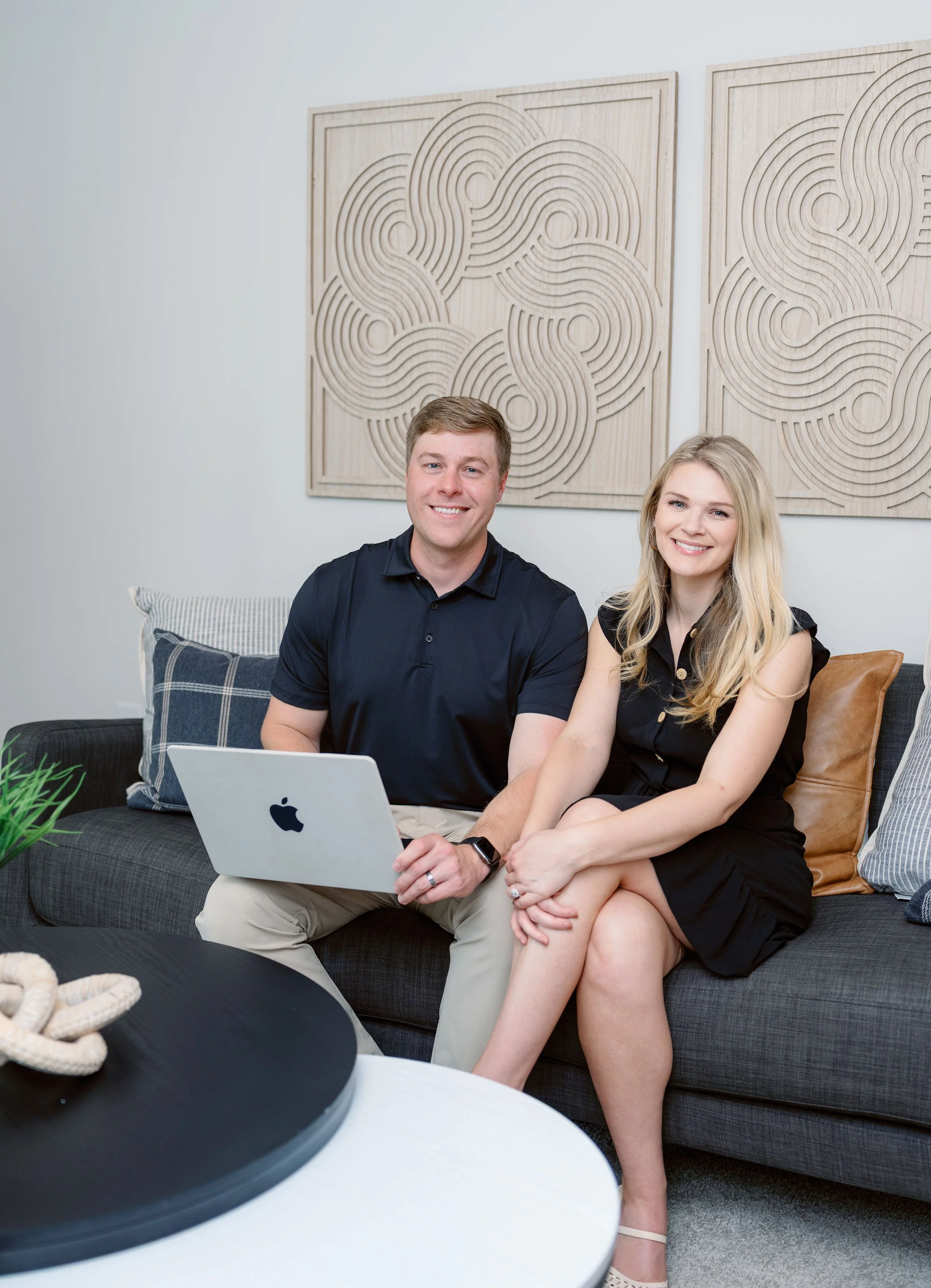 Emily Styles and Harrison Styles sitting on a couch.