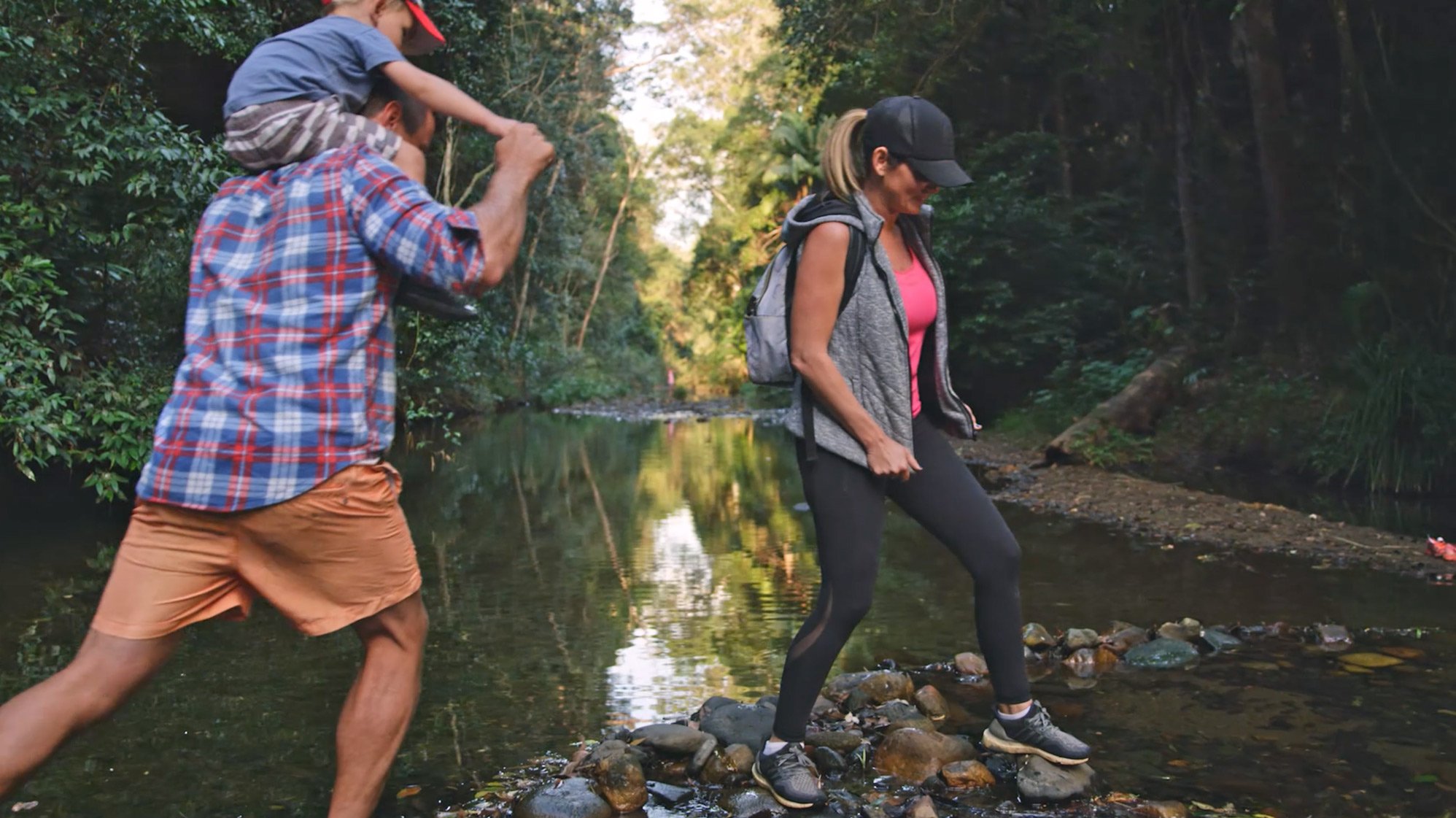 An active family crossing a river