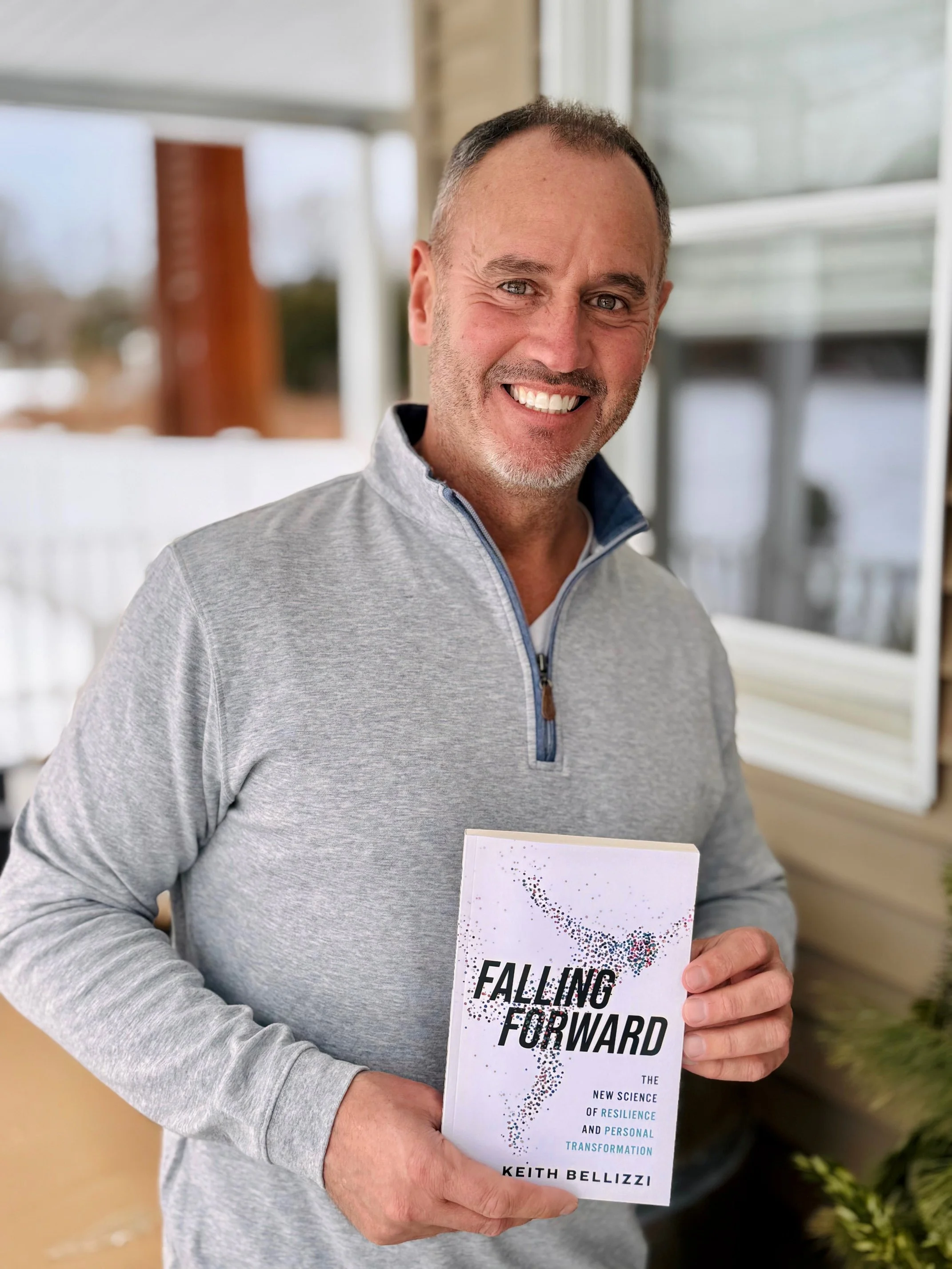 Keith Bellizzi holding Falling Forward book