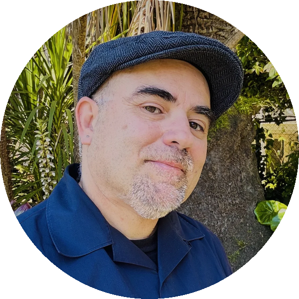 Author S.A. Mireles in a cap among tropical plants