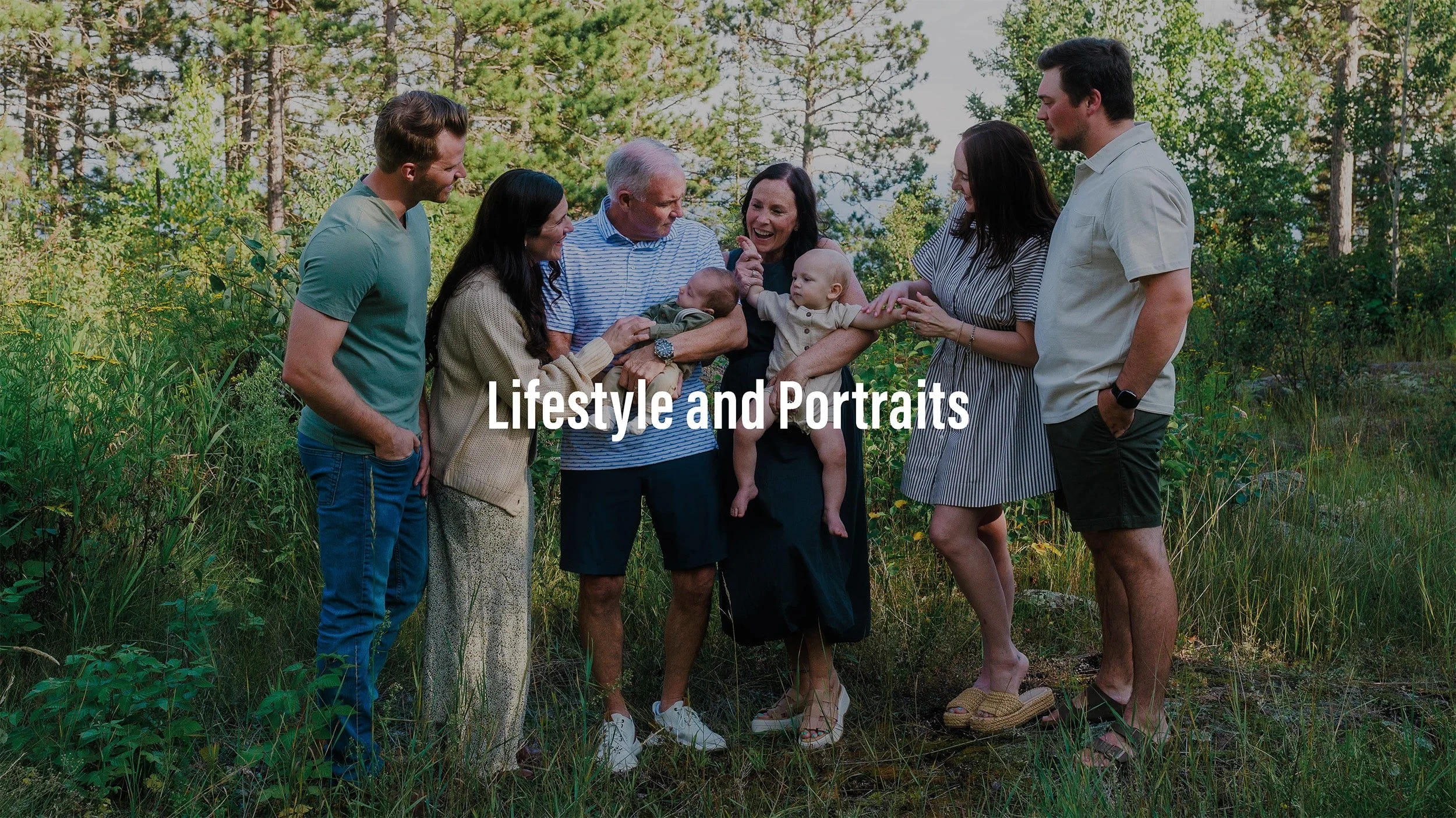 Group of seven people, including children, gathered outdoors in a green, wooded area, smiling and interacting with each other, with the text "Lifestyle and Portraits" overlaid.