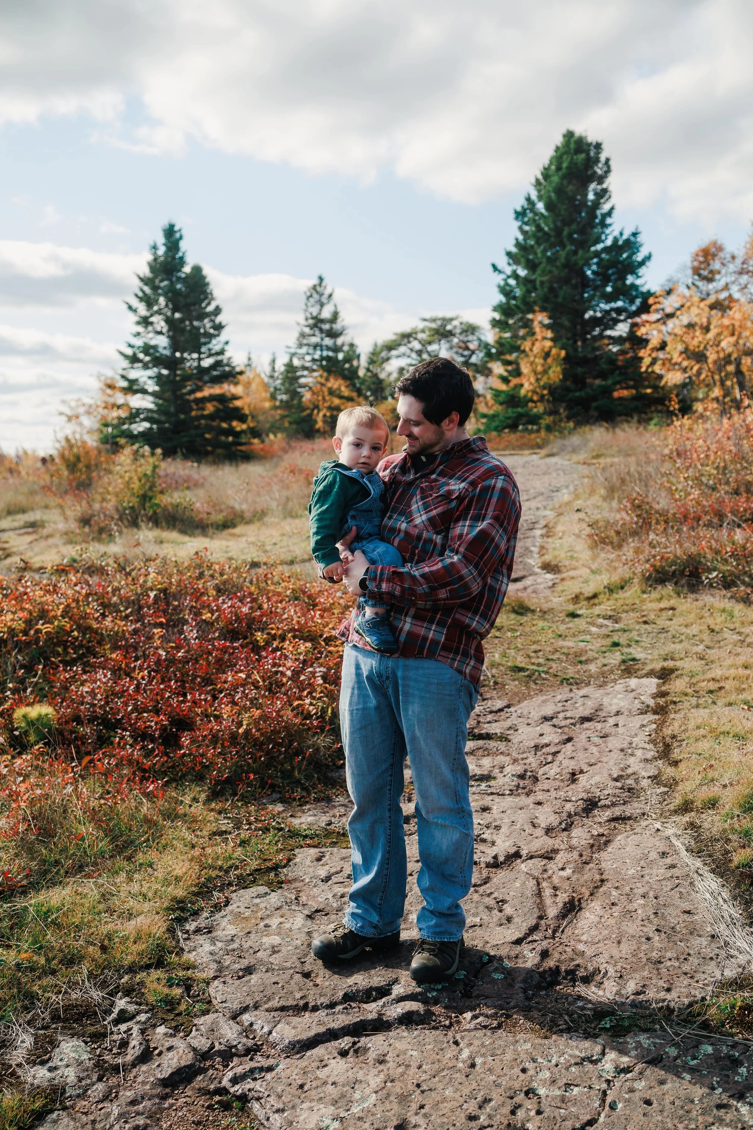 Man holding son in family portrait in Gooseberry State Park
