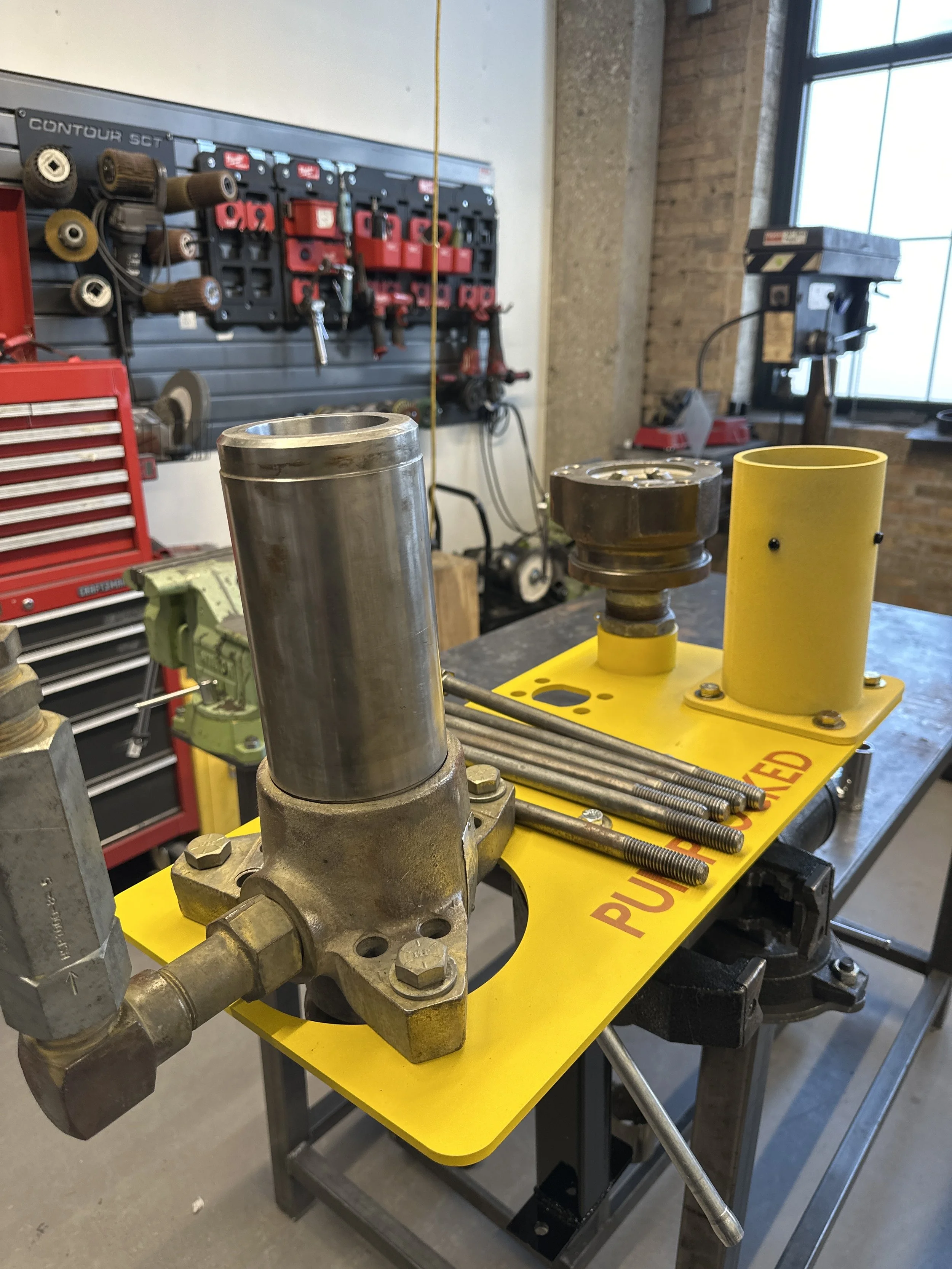 PumpLocked platform set up in shop. Disassembling Graco 1800 displacement pump
