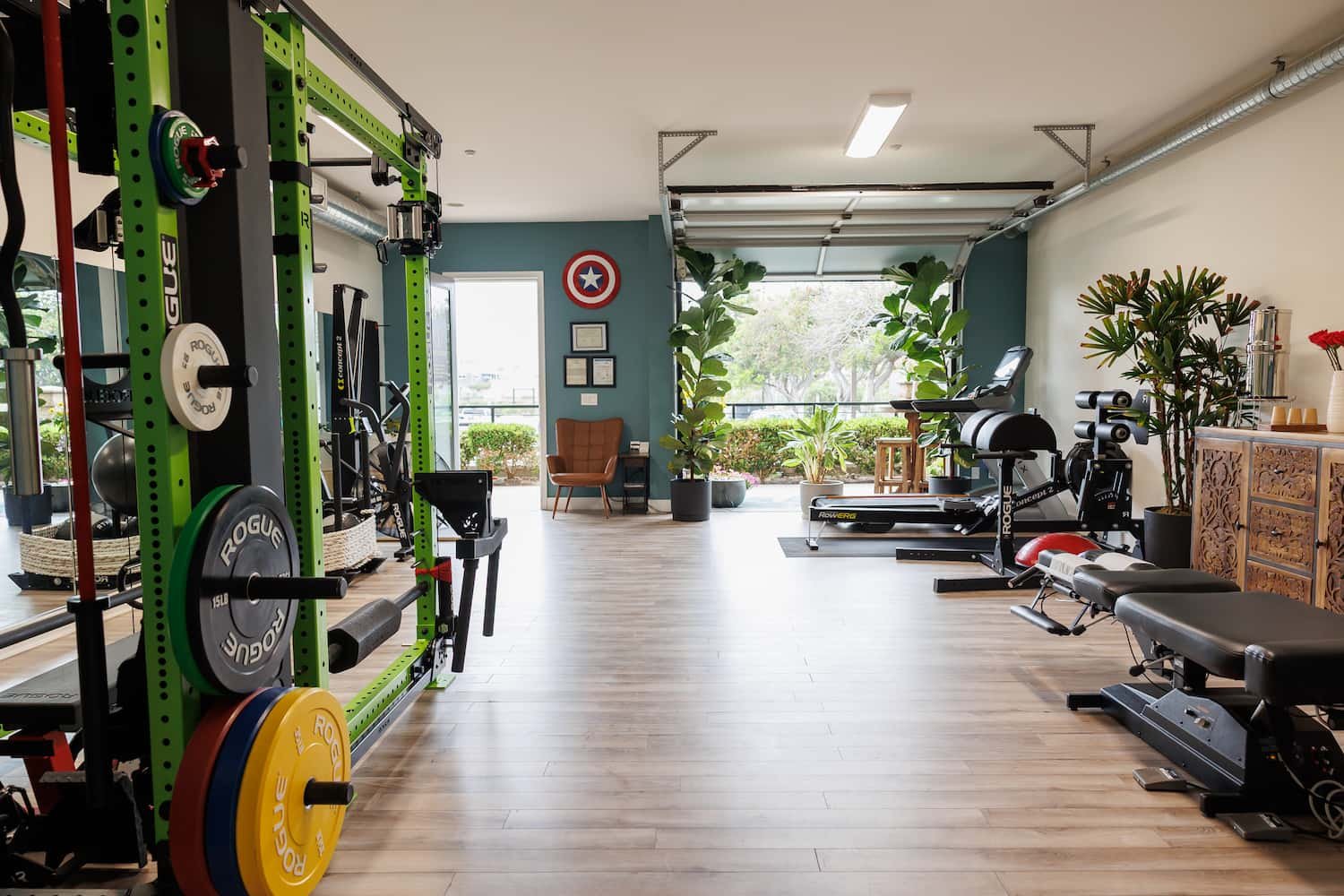 Private chiropractic gym with barbell and strength training equipment at Structure Chiropractic Carlsbad CA