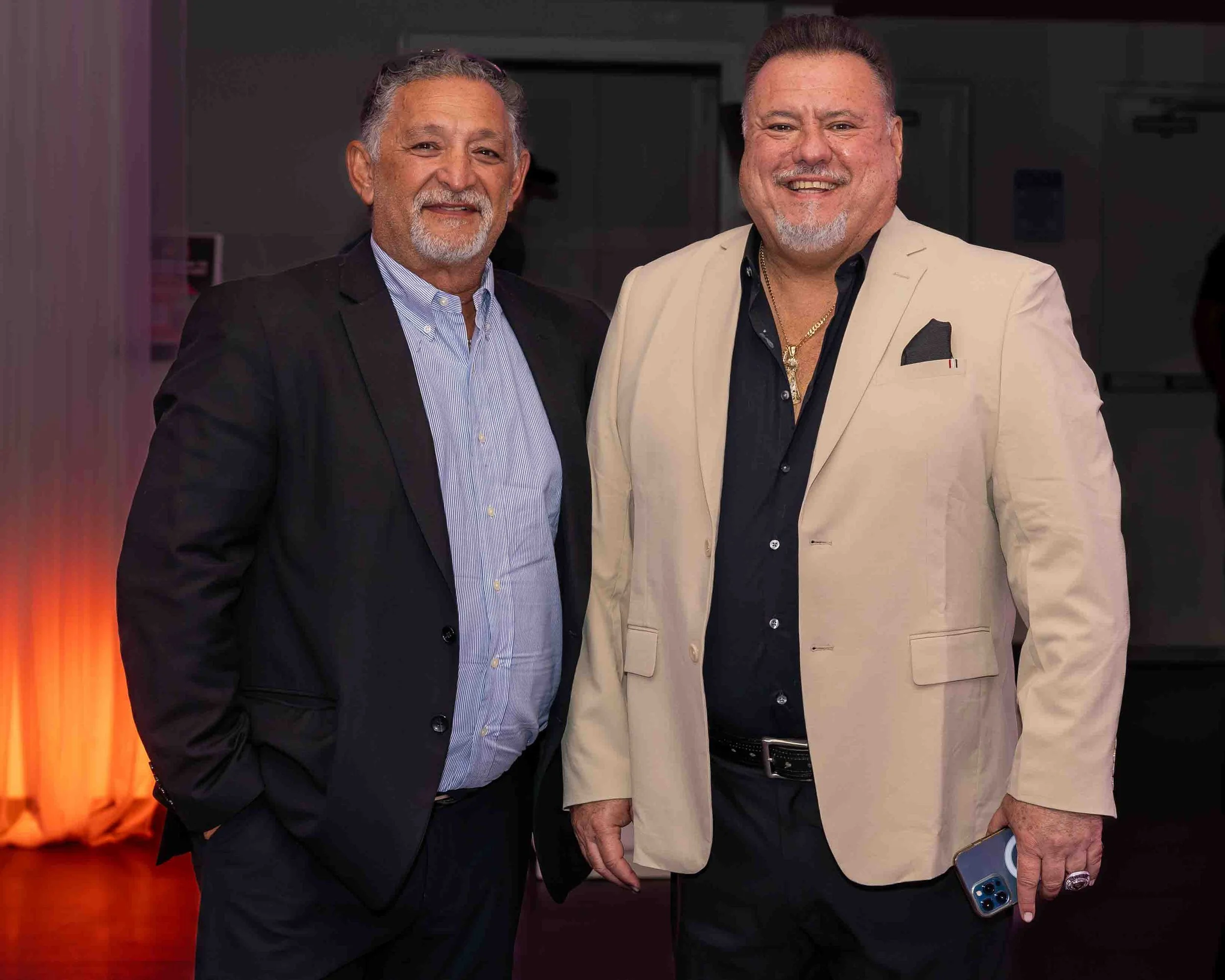 ABF Academy Principal Manny Riera and Miami Prep CEO Art 'Pilin' Alvarez in suits smiling and standing together at a Sports Banquet.