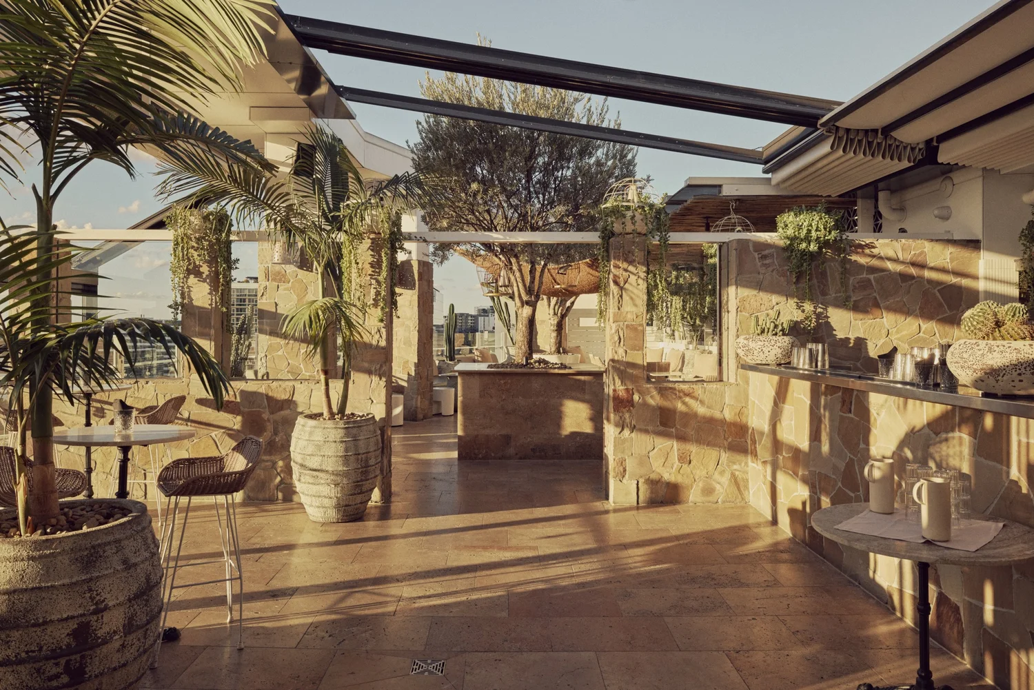 Patio Bar at MAYA in late afternoon light with high tables