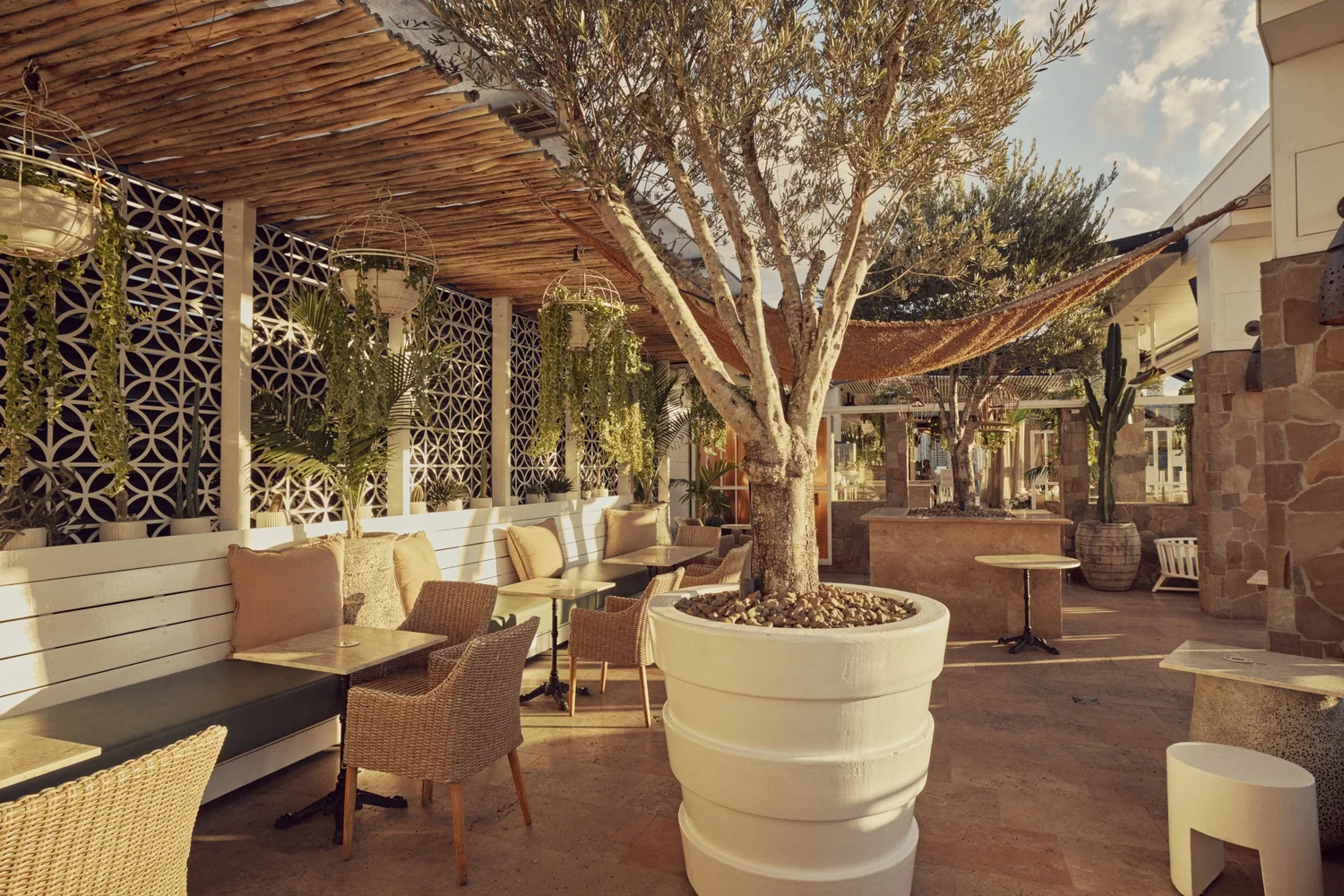 Banquette seating in the MAYA Courtyard under a timber pergola