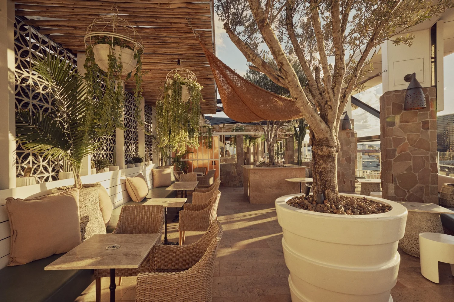 MAYA Courtyard tables and lounge seating in afternoon sun