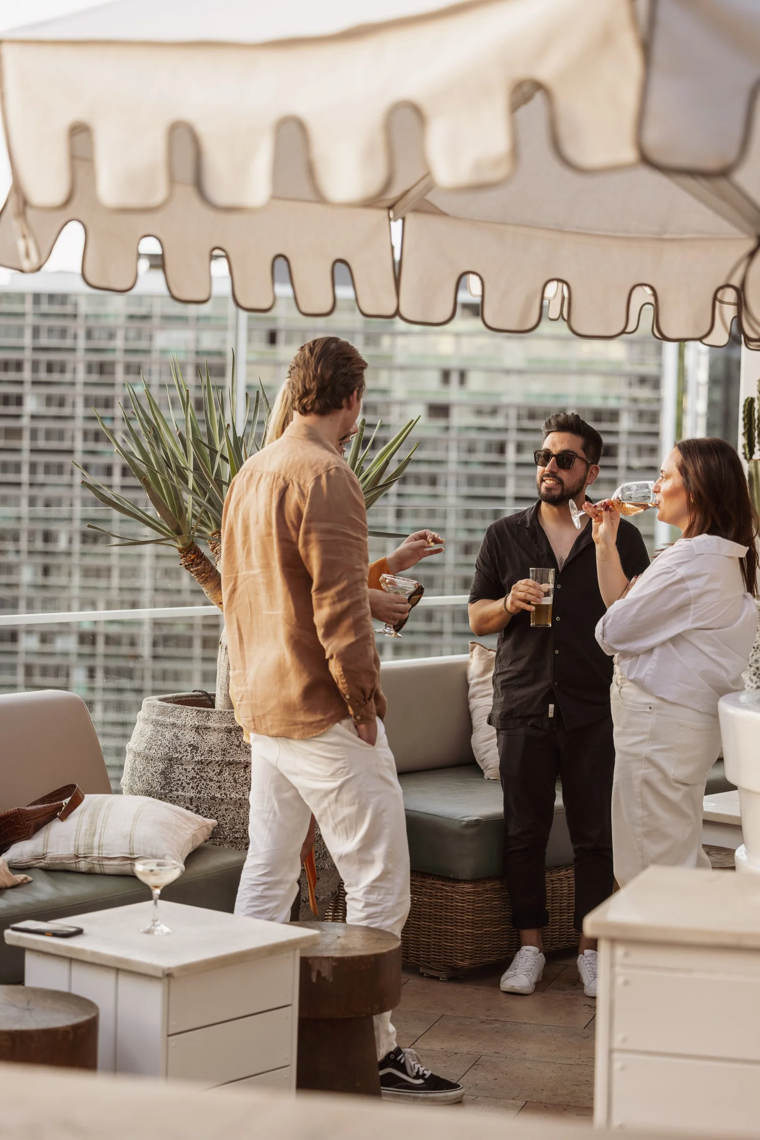 Guests sharing drinks on the MAYA rooftop during a cocktail party